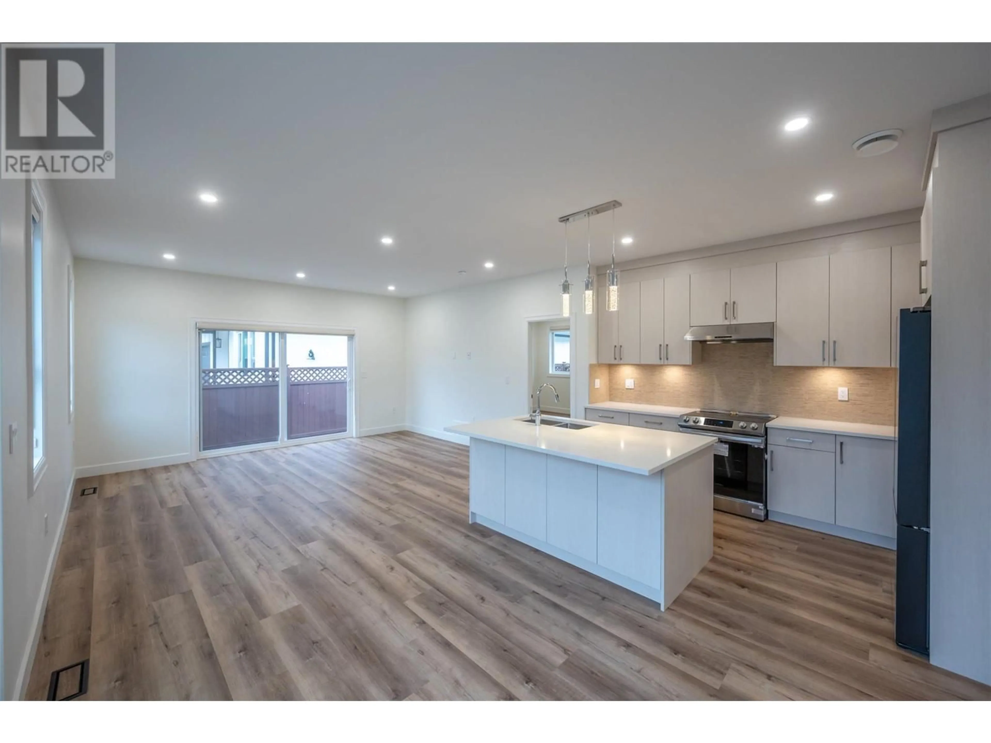 Open concept kitchen, wood/laminate floor for 258 BENTGRASS Avenue, Oliver British Columbia V0H1T3