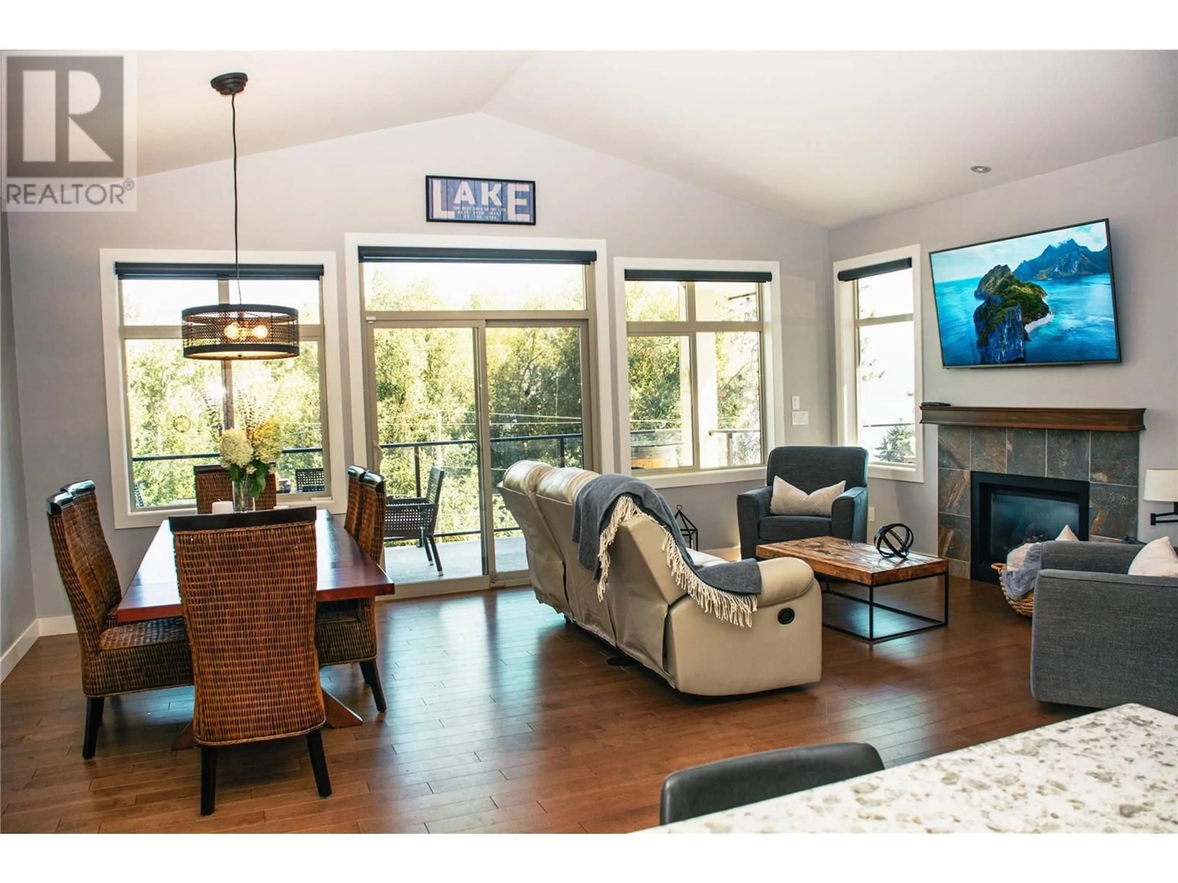 Living room with furniture, wood/laminate floor for 6278 Bulyea Avenue, Peachland British Columbia V0H1X7