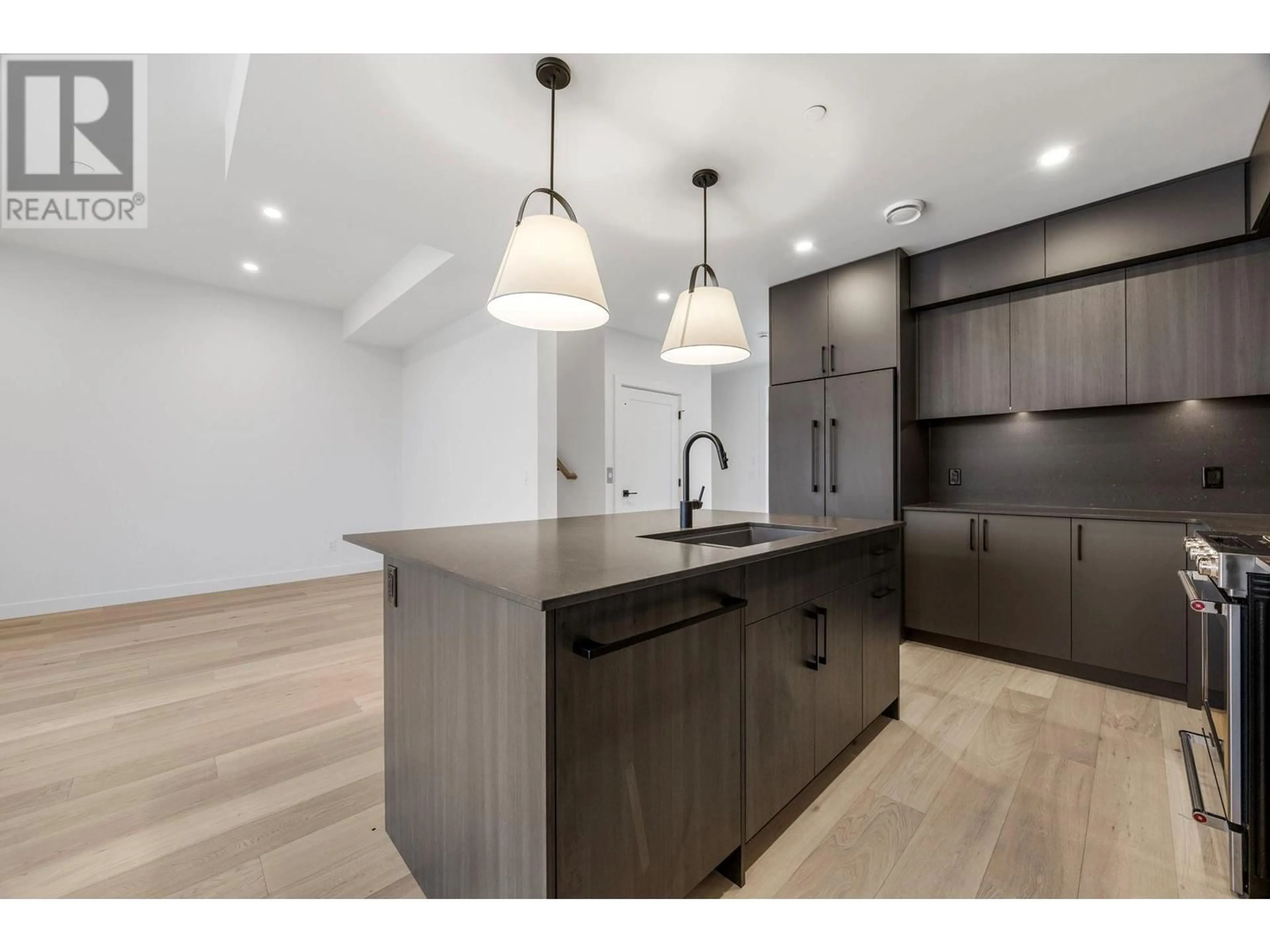 Open concept kitchen, wood/laminate floor for 6012 Princess Street, Peachland British Columbia V0H1X7