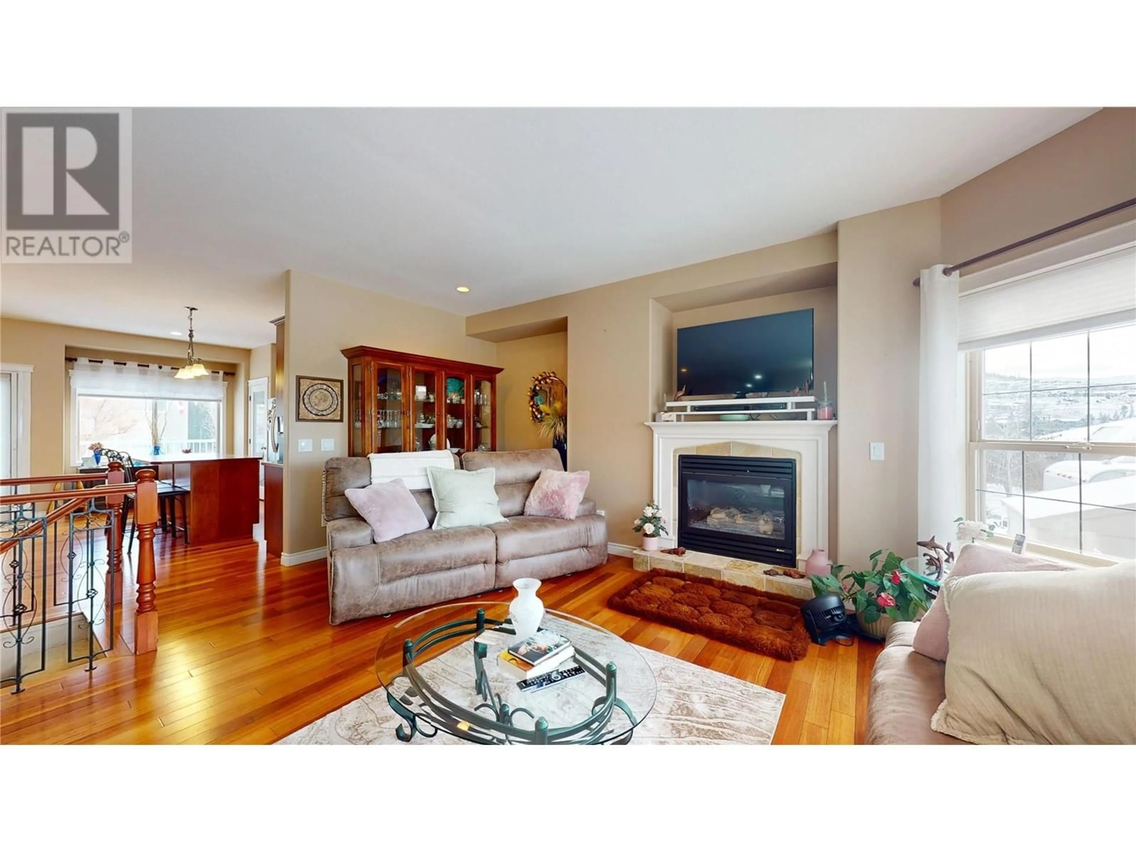 Living room with furniture, wood/laminate floor for 1505 TANEMURA CRESCENT, Kelowna British Columbia V1P1N8