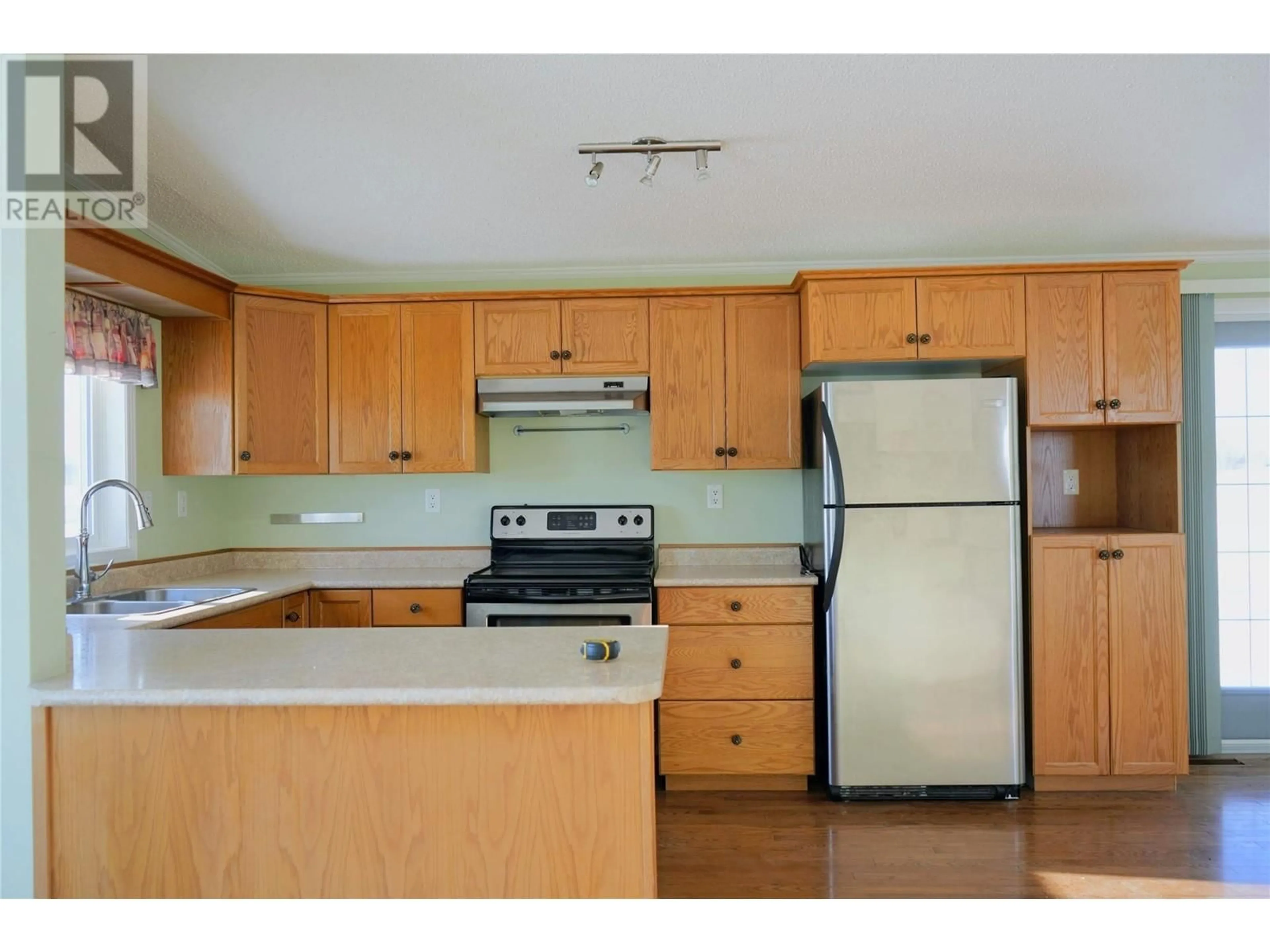 Open concept kitchen, wood/laminate floor for 9 - 9800 18 STREET, Dawson Creek British Columbia V1G5A4