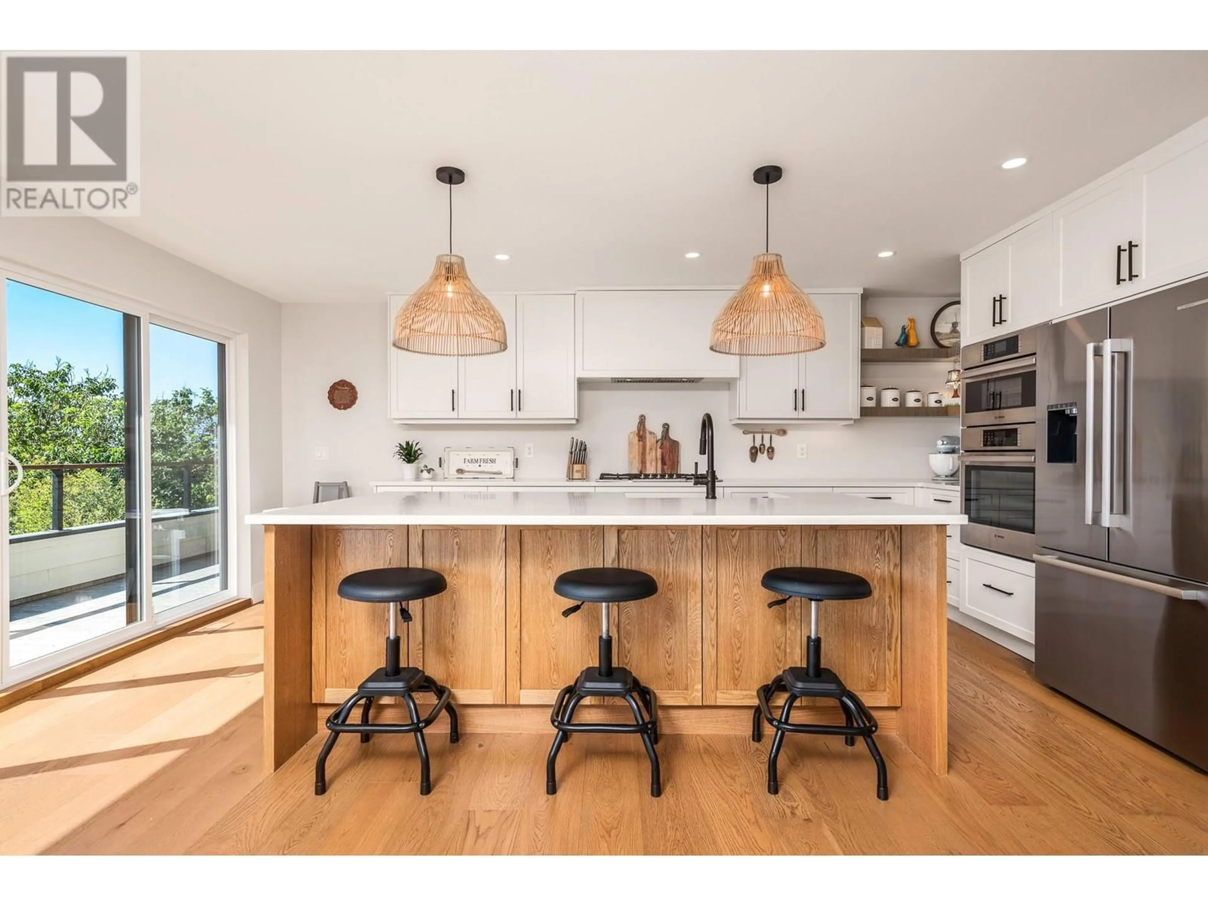 Open concept kitchen, wood/laminate floor for 7463 Tronson Road, Vernon British Columbia V1H1C3