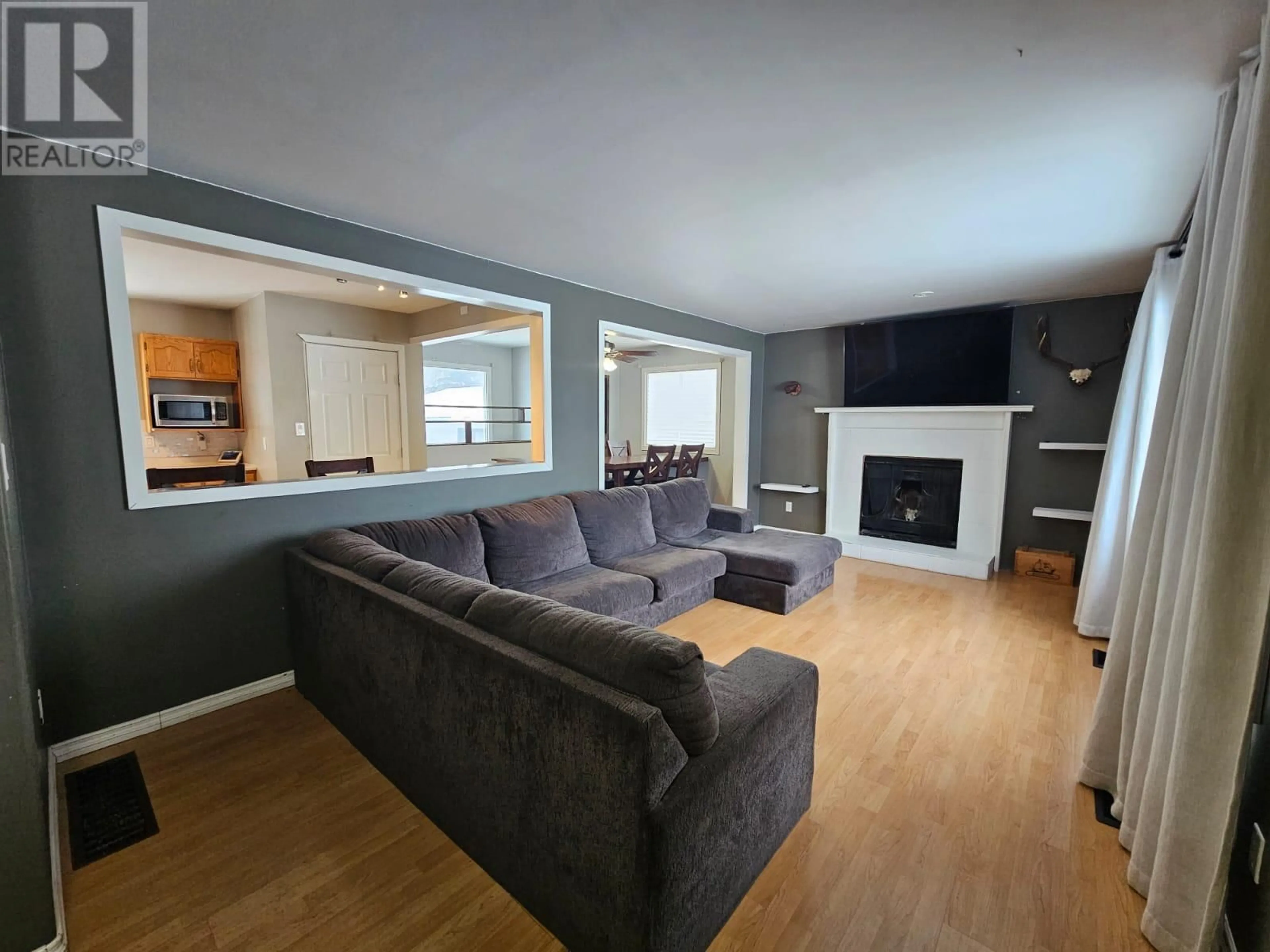 Living room with furniture, wood/laminate floor for 4408 50A NE AVENUE, Chetwynd British Columbia V0C1J0