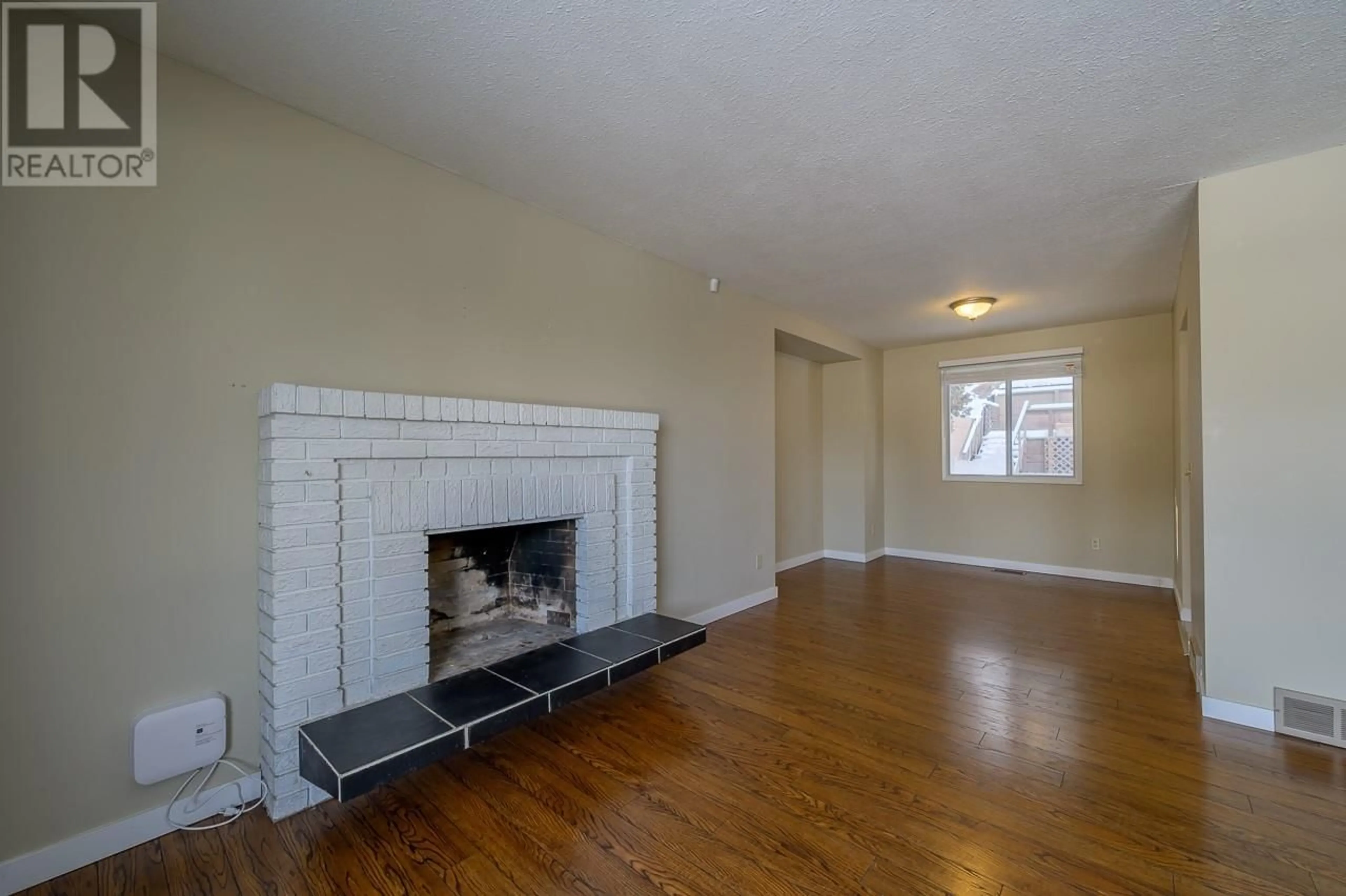 Living room with furniture, wood/laminate floor for 2108 VAN HORNE Drive, Kamloops British Columbia V1S1G2