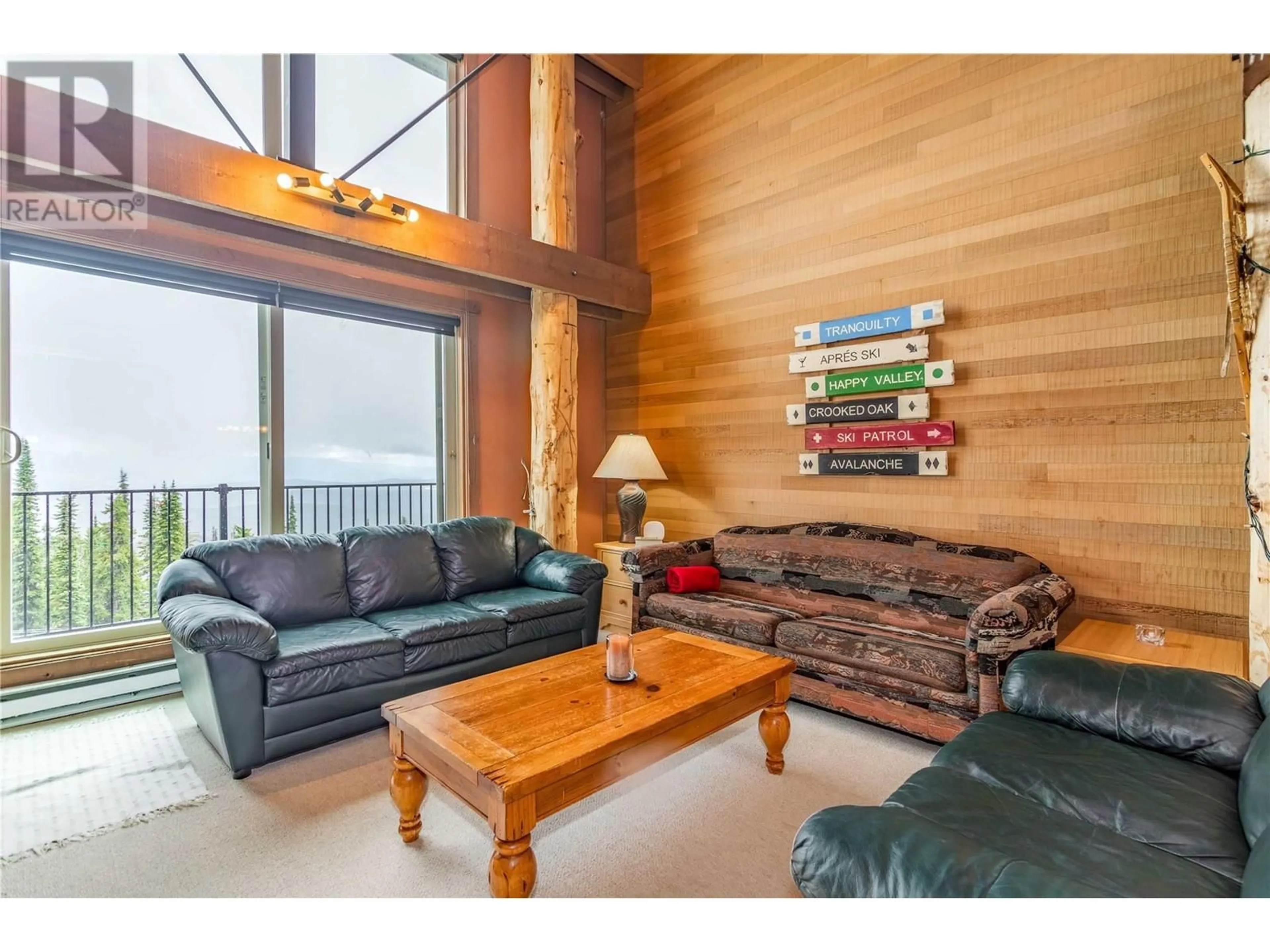 Living room with furniture, wood/laminate floor for 7470 Porcupine Road Unit# 608, Kelowna British Columbia V1X4K5