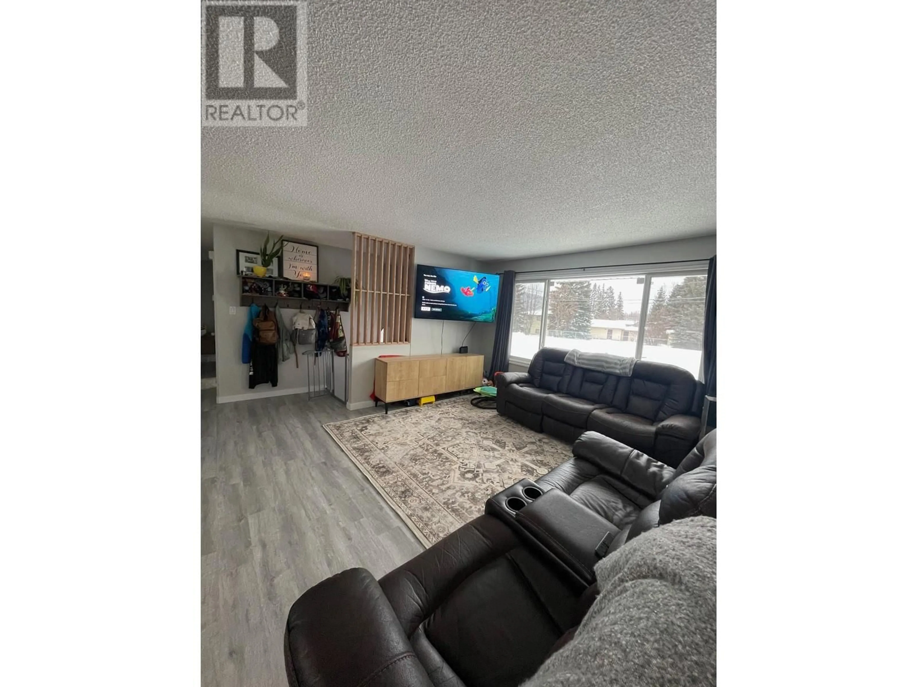 Living room with furniture, wood/laminate floor for 4604 49 NE Avenue, Chetwynd British Columbia V0C1J0