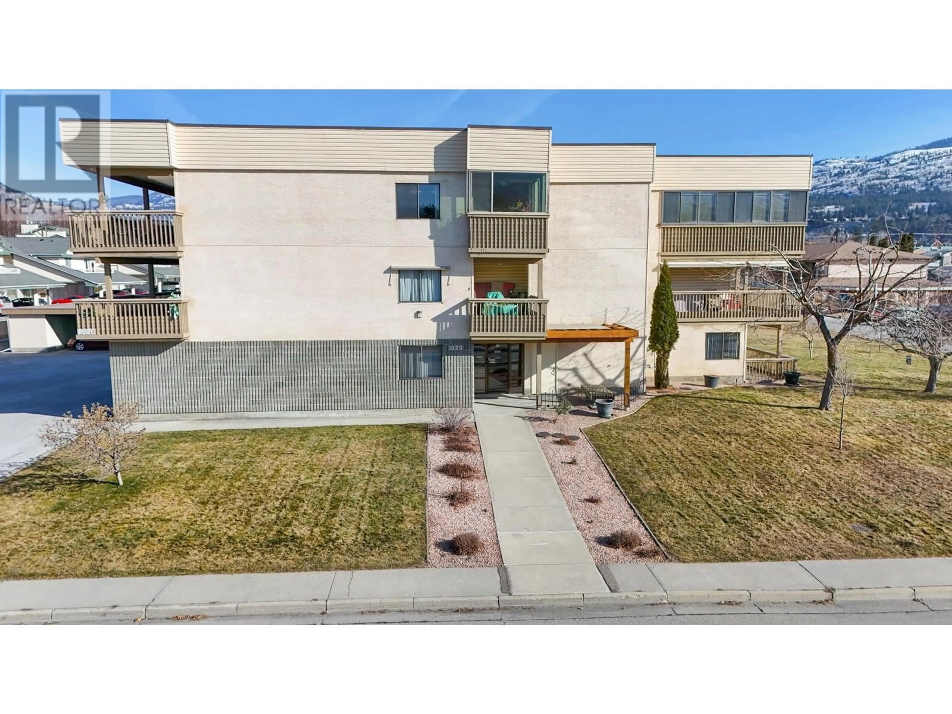 A pic from outside/outdoor area/front of a property/back of a property/a pic from drone, unknown for 1820 ATKINSON Street Unit# 207, Penticton British Columbia V2A7M6