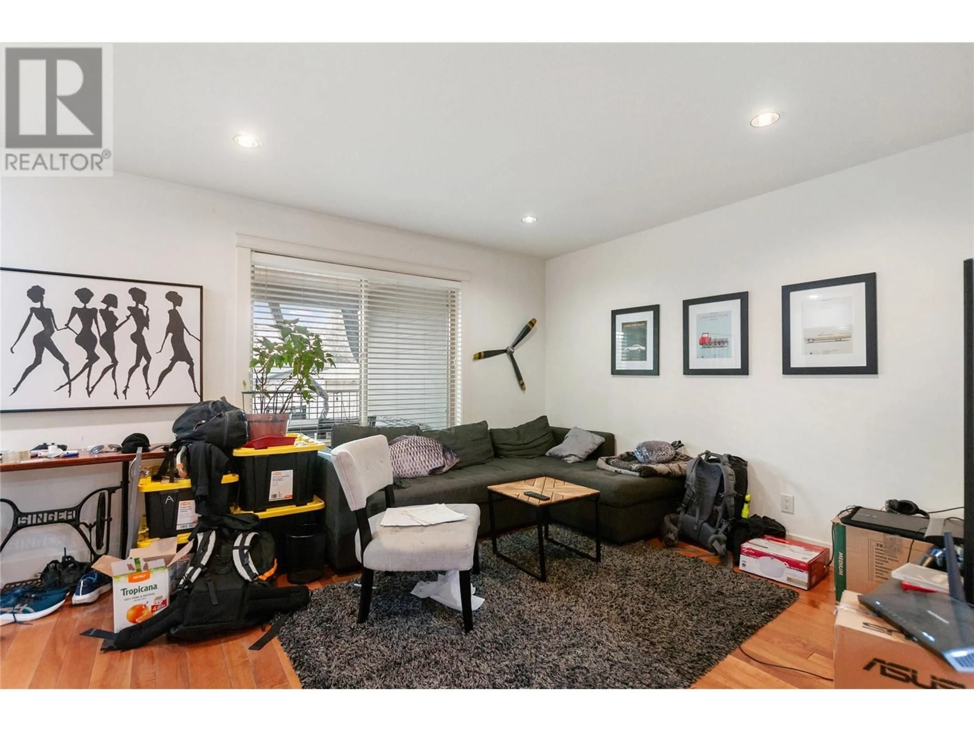 Living room with furniture, wood/laminate floor for 741 Clement Avenue, Kelowna British Columbia V1Y7C9