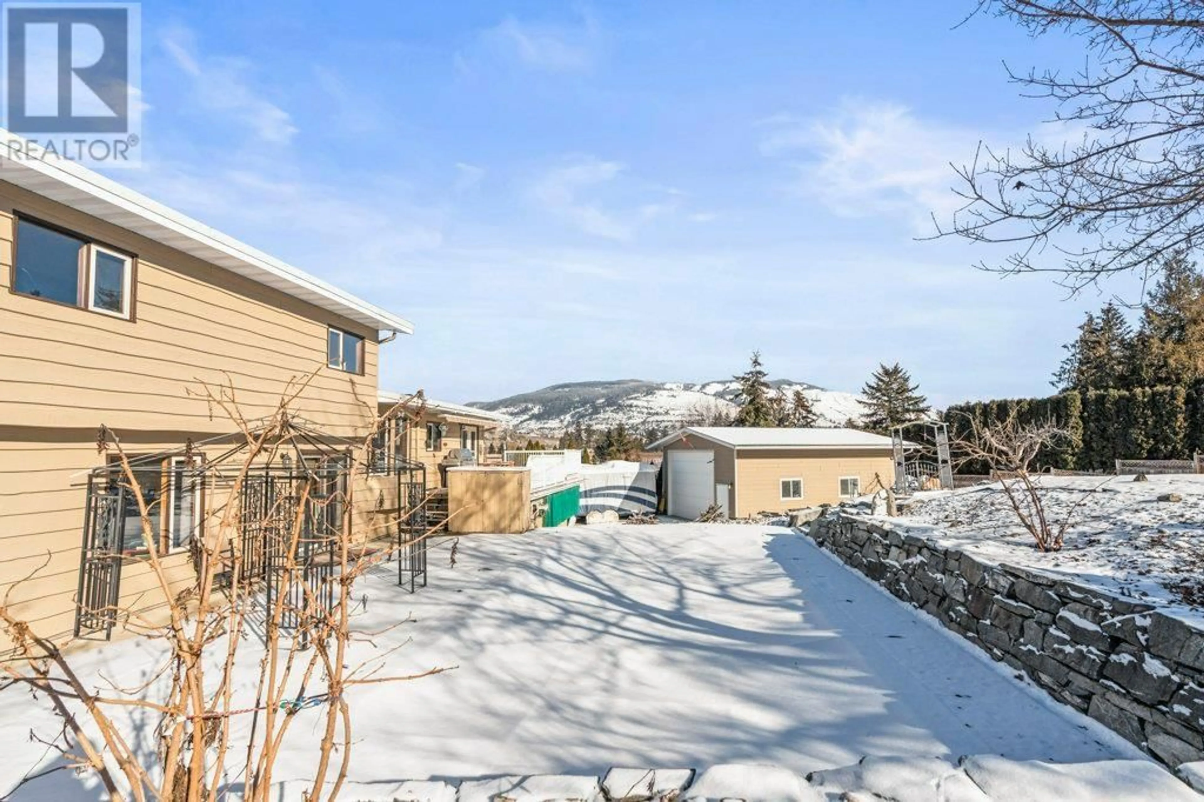 A pic from outside/outdoor area/front of a property/back of a property/a pic from drone, mountain view for 11410 Tassie Drive, Coldstream British Columbia V1B1H4