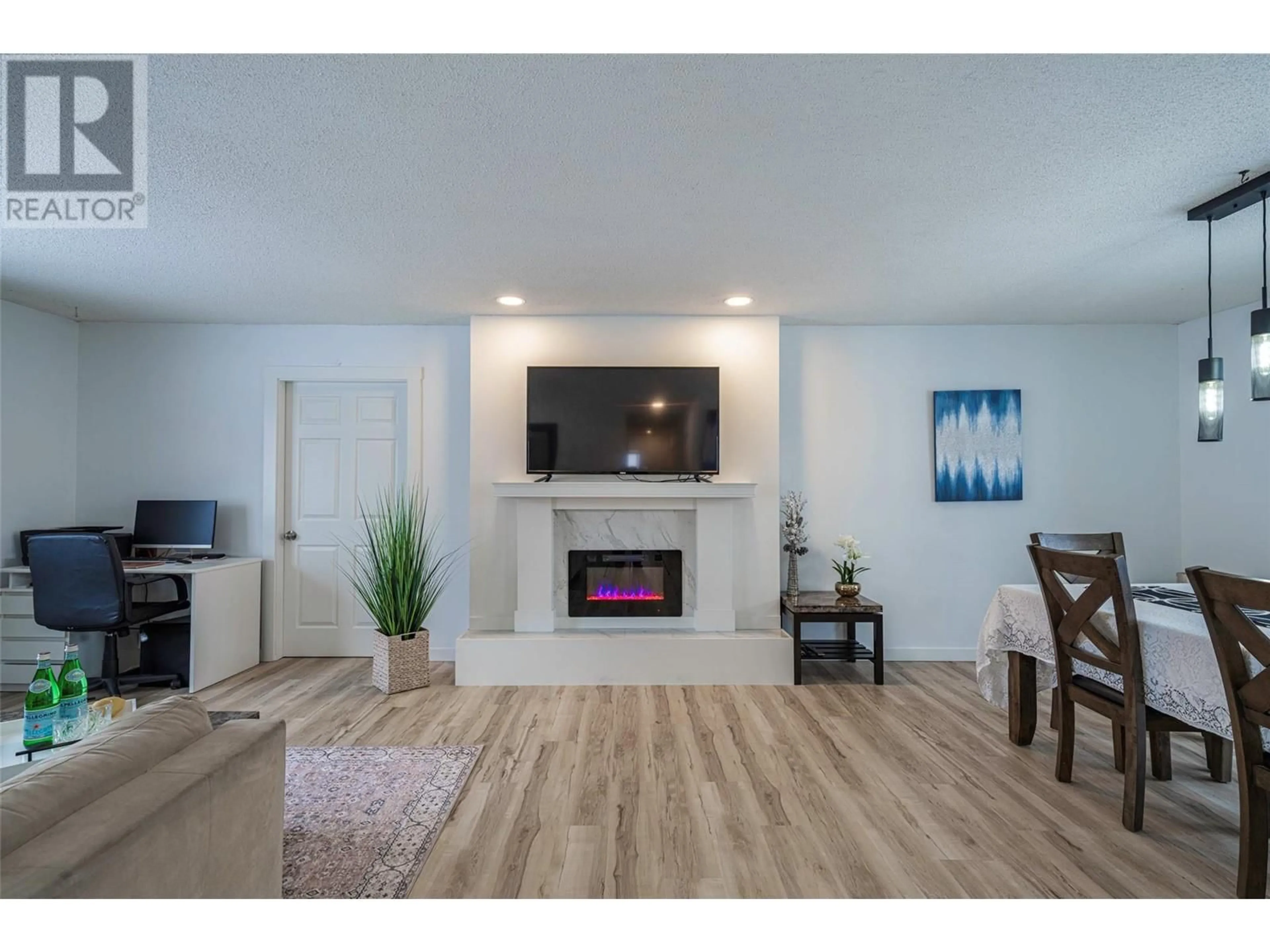 Living room with furniture, wood/laminate floor for 2412 Butt Road, West Kelowna British Columbia V4T1N7