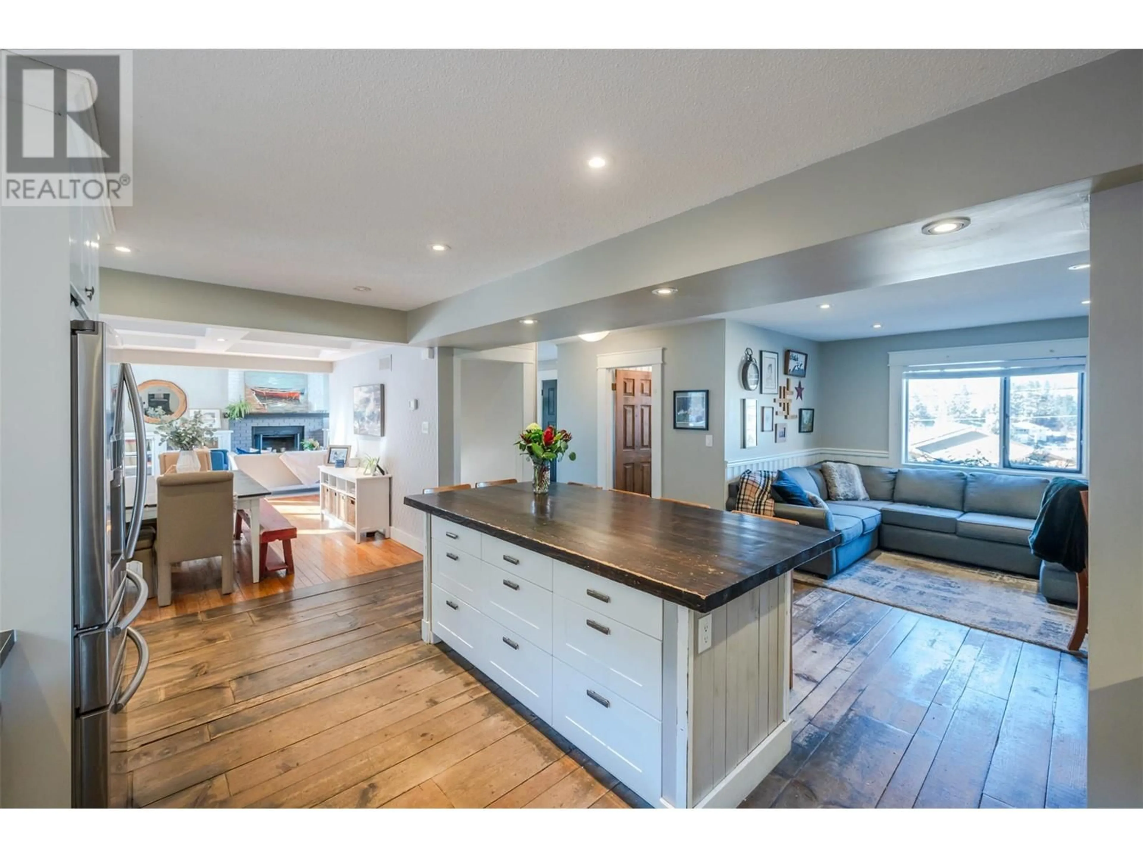 Open concept kitchen, wood/laminate floor for 10613 Mountford Avenue, Summerland British Columbia V0H1Z2