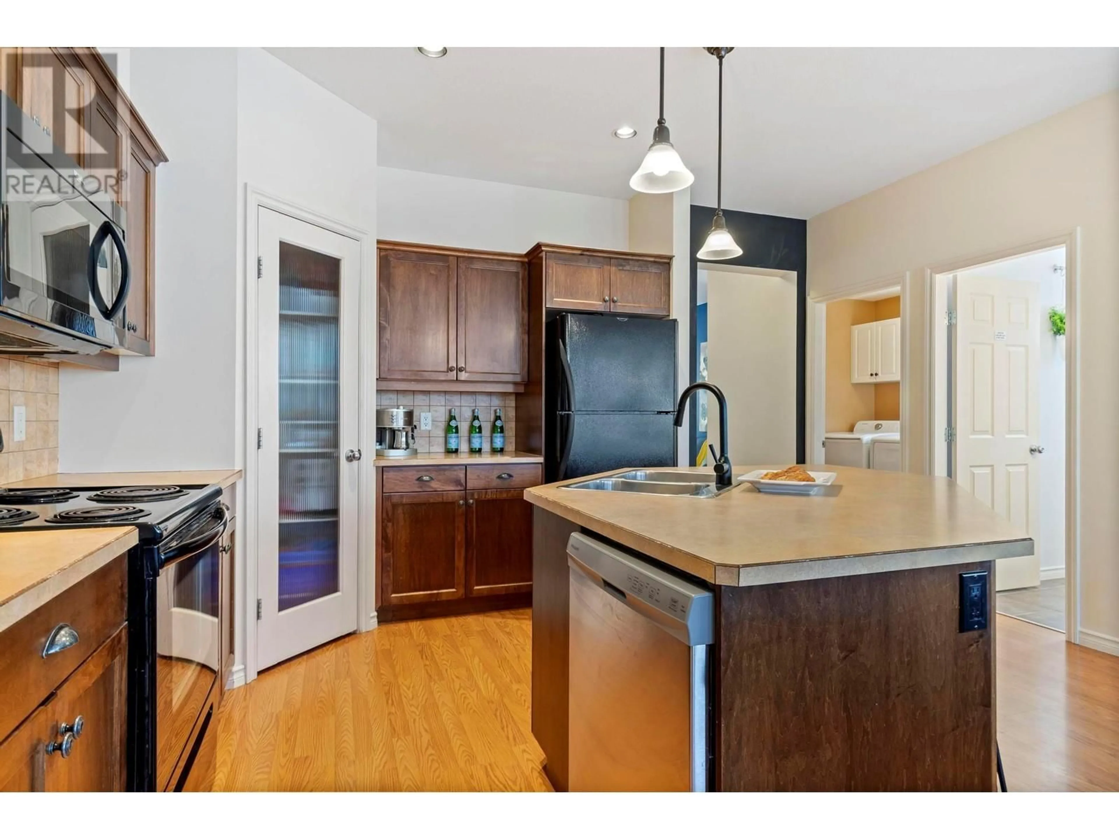 Open concept kitchen, wood/laminate floor for 380 Providence Avenue Unit# 24, Kelowna British Columbia V1W4Z6