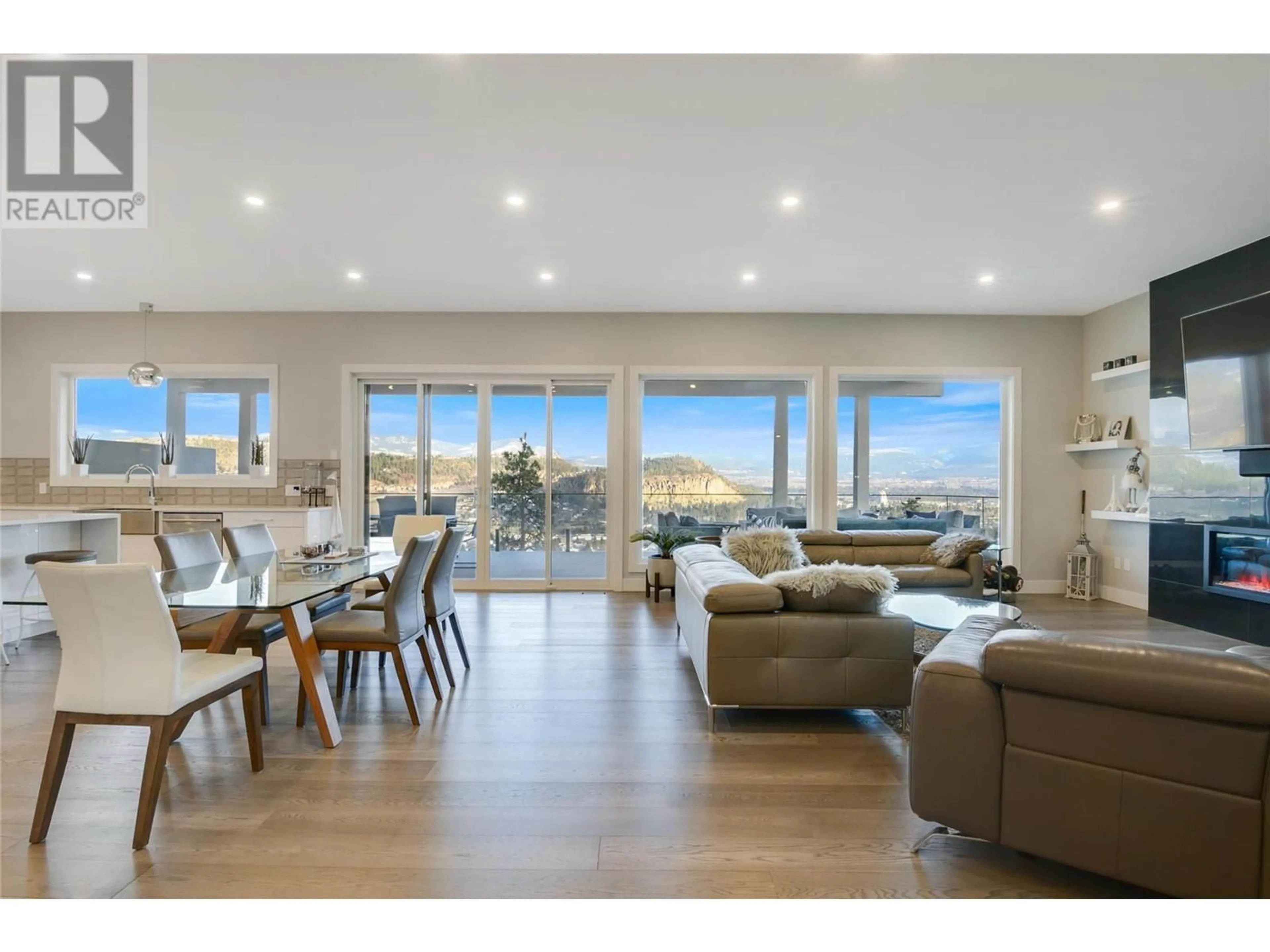 Living room with furniture, wood/laminate floor for 761 Highpointe Lane, Kelowna British Columbia V1V2Y1