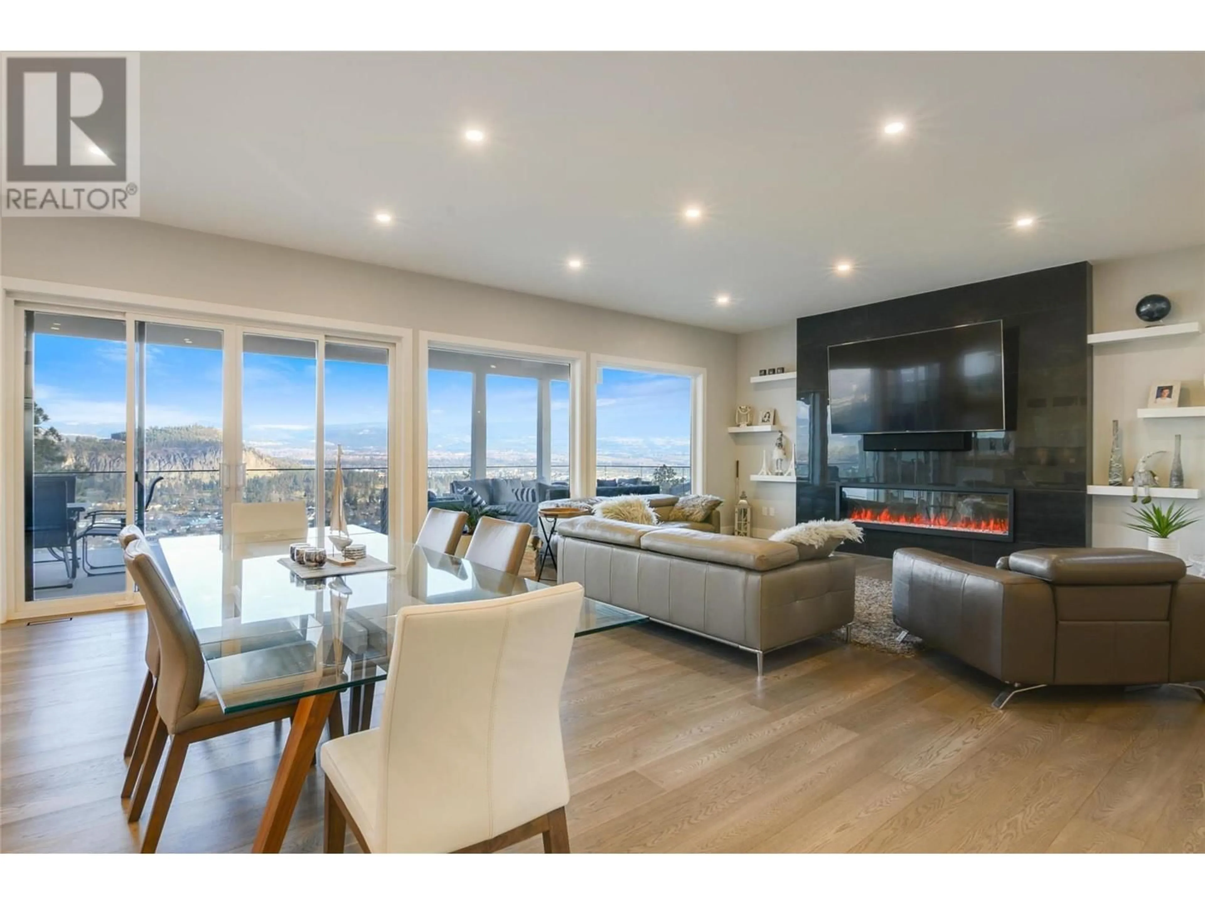 Living room with furniture, wood/laminate floor for 761 Highpointe Lane, Kelowna British Columbia V1V2Y1