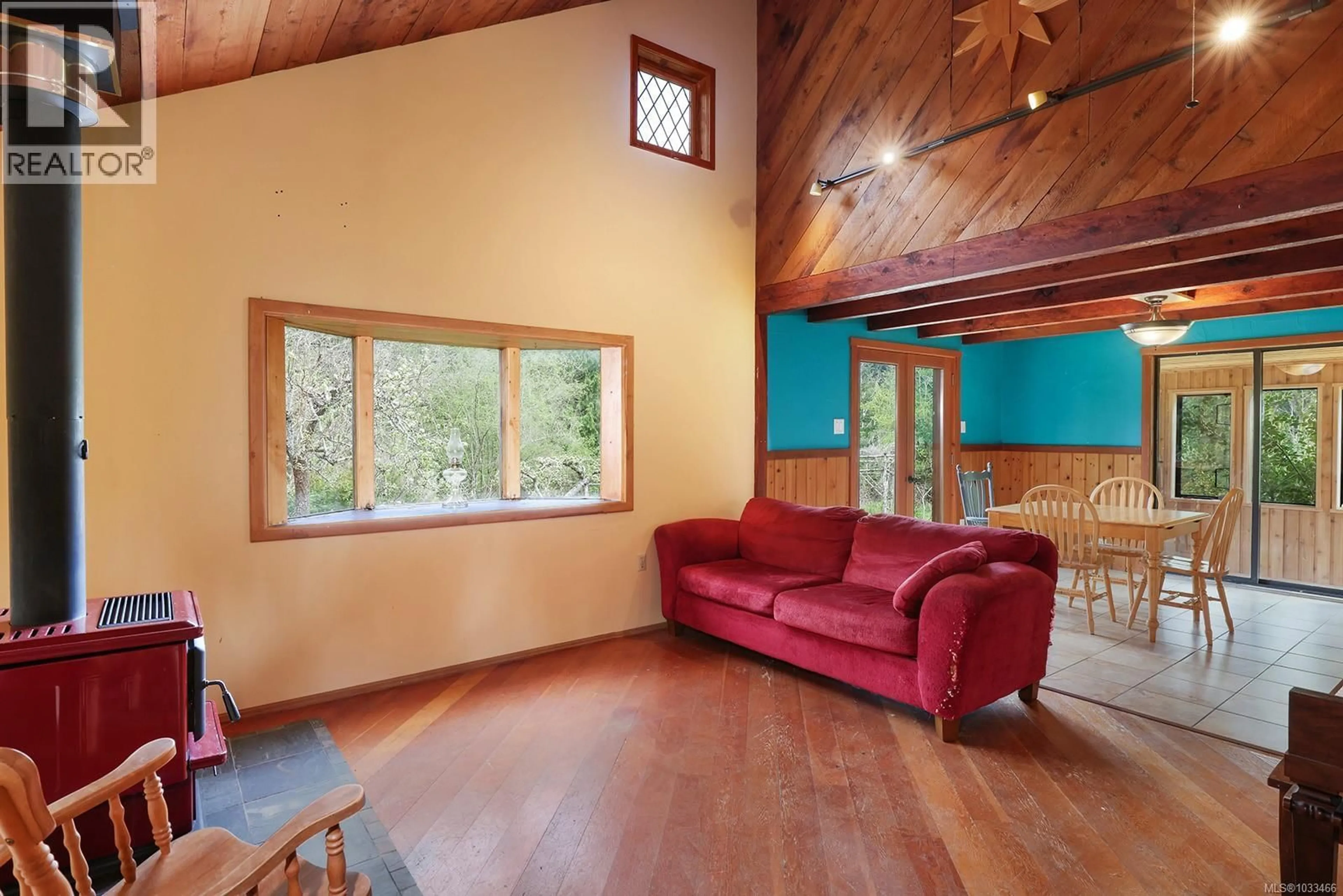 Living room with furniture, wood/laminate floor for 9210 MCFARLANE ROAD, Denman Island British Columbia V0R1T0