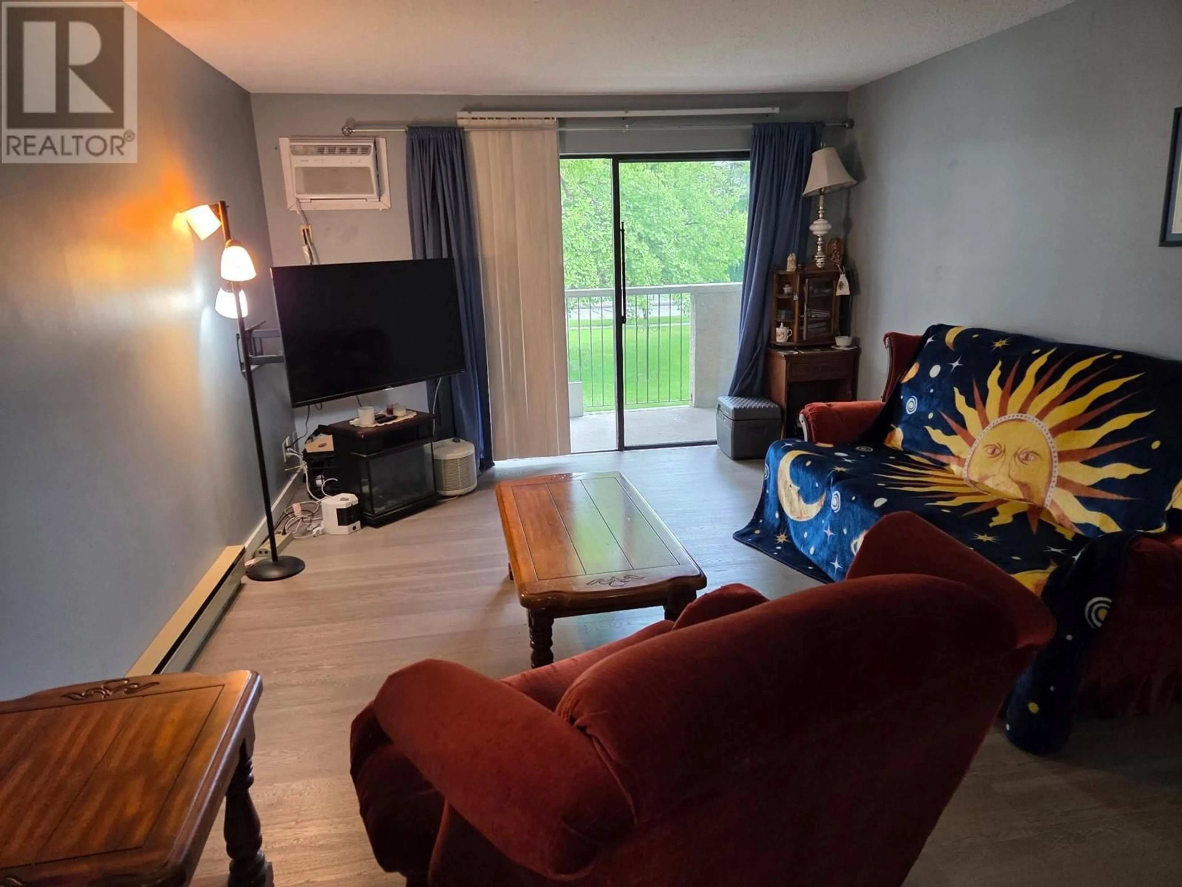 Living room with furniture, wood/laminate floor for 108 - 3701 27 AVENUE, Vernon British Columbia V1T1S5