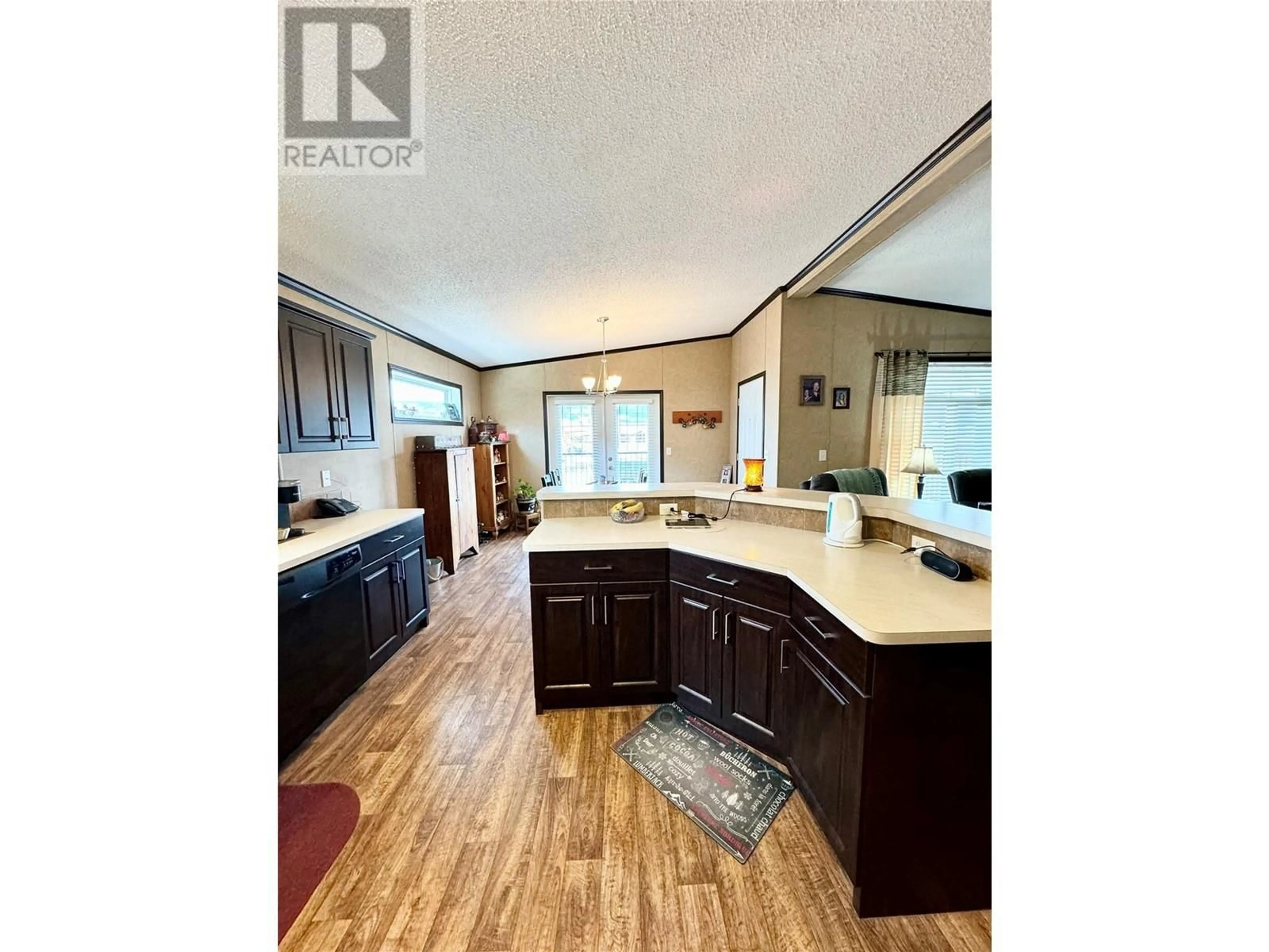 Open concept kitchen, wood/laminate floor for 2581 Spring Bank Avenue, Merritt British Columbia V1K1S1