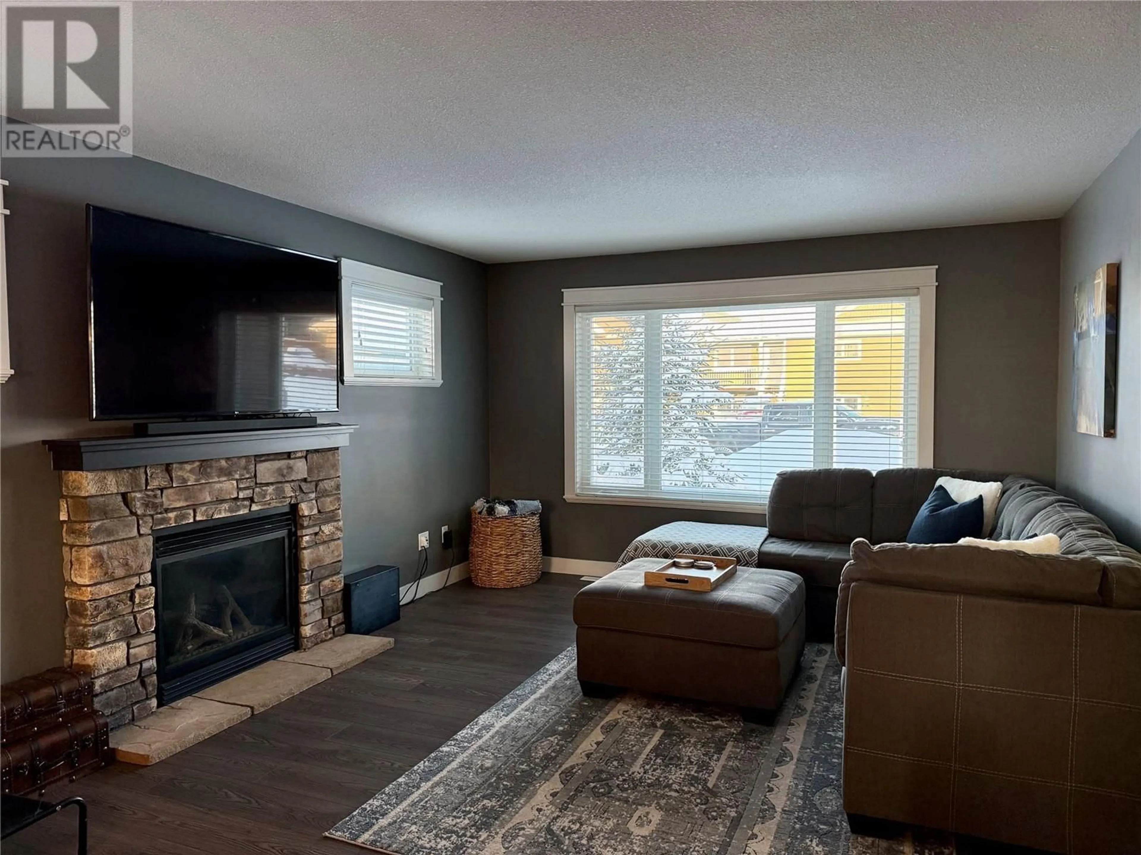 Living room with furniture, wood/laminate floor for 1825 84 Avenue, Dawson Creek British Columbia V1G0E4