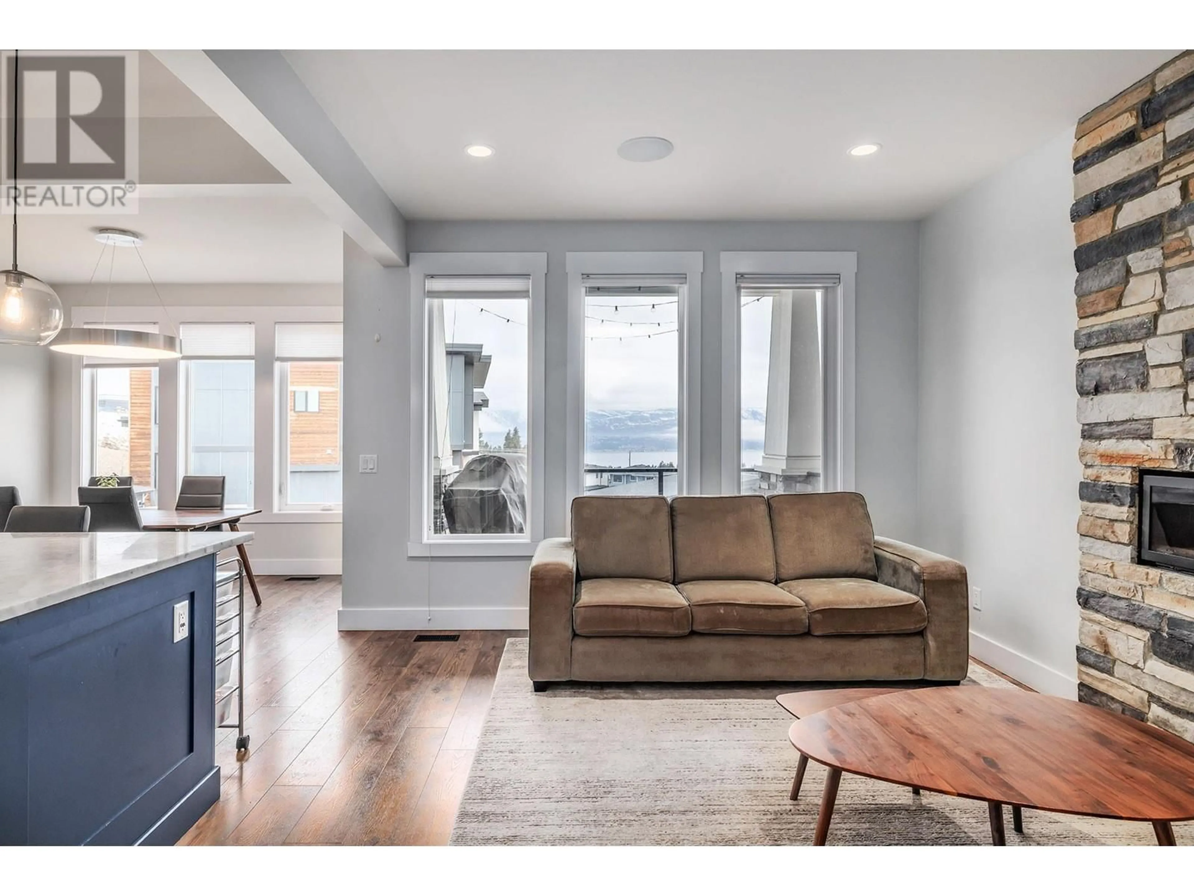 Living room with furniture, wood/laminate floor for 1164 Frost Road, Kelowna British Columbia V1W5M1