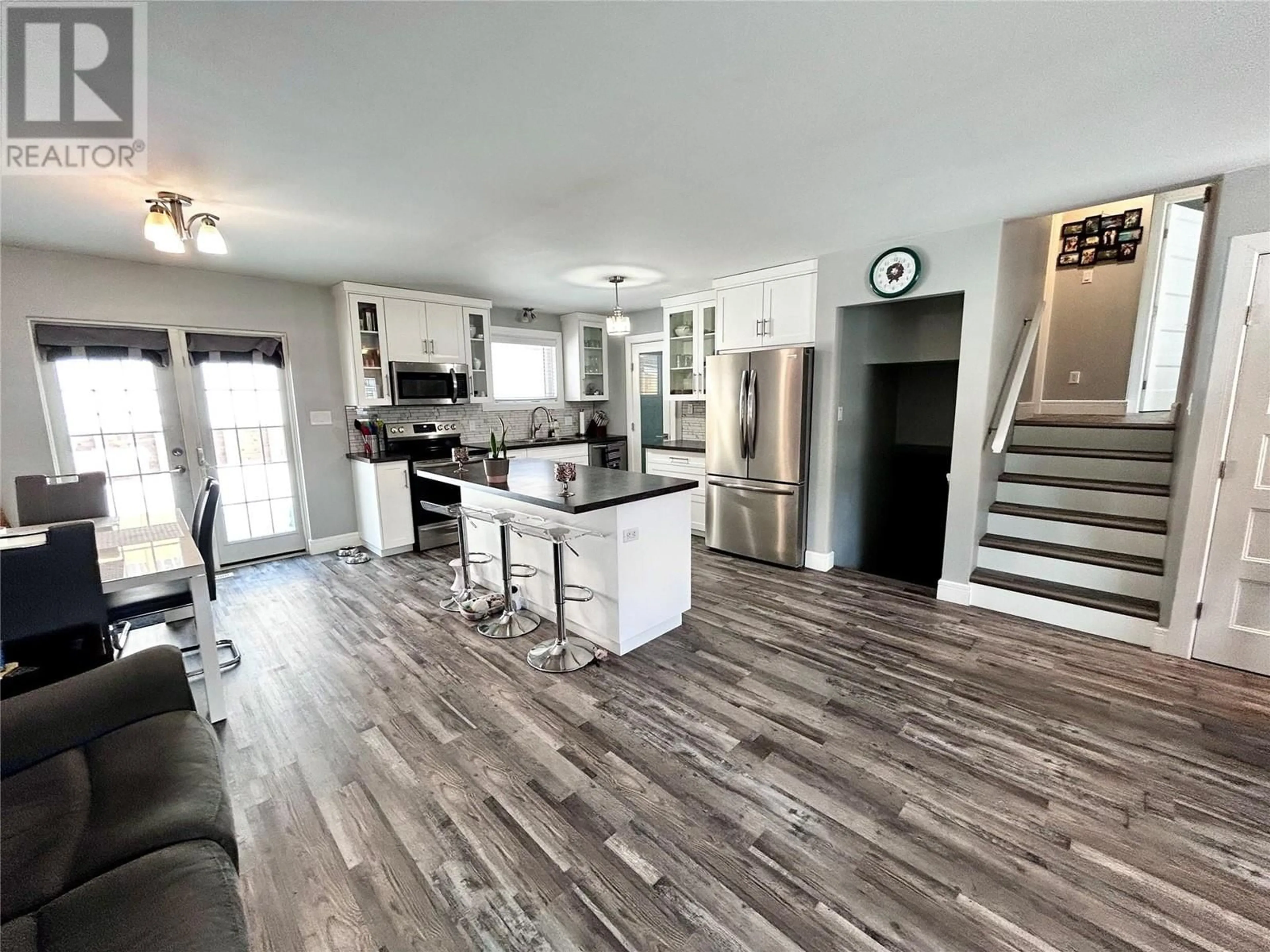 Open concept kitchen, wood/laminate floor for 164 Gwillim Crescent, Tumbler Ridge British Columbia V0C2W0