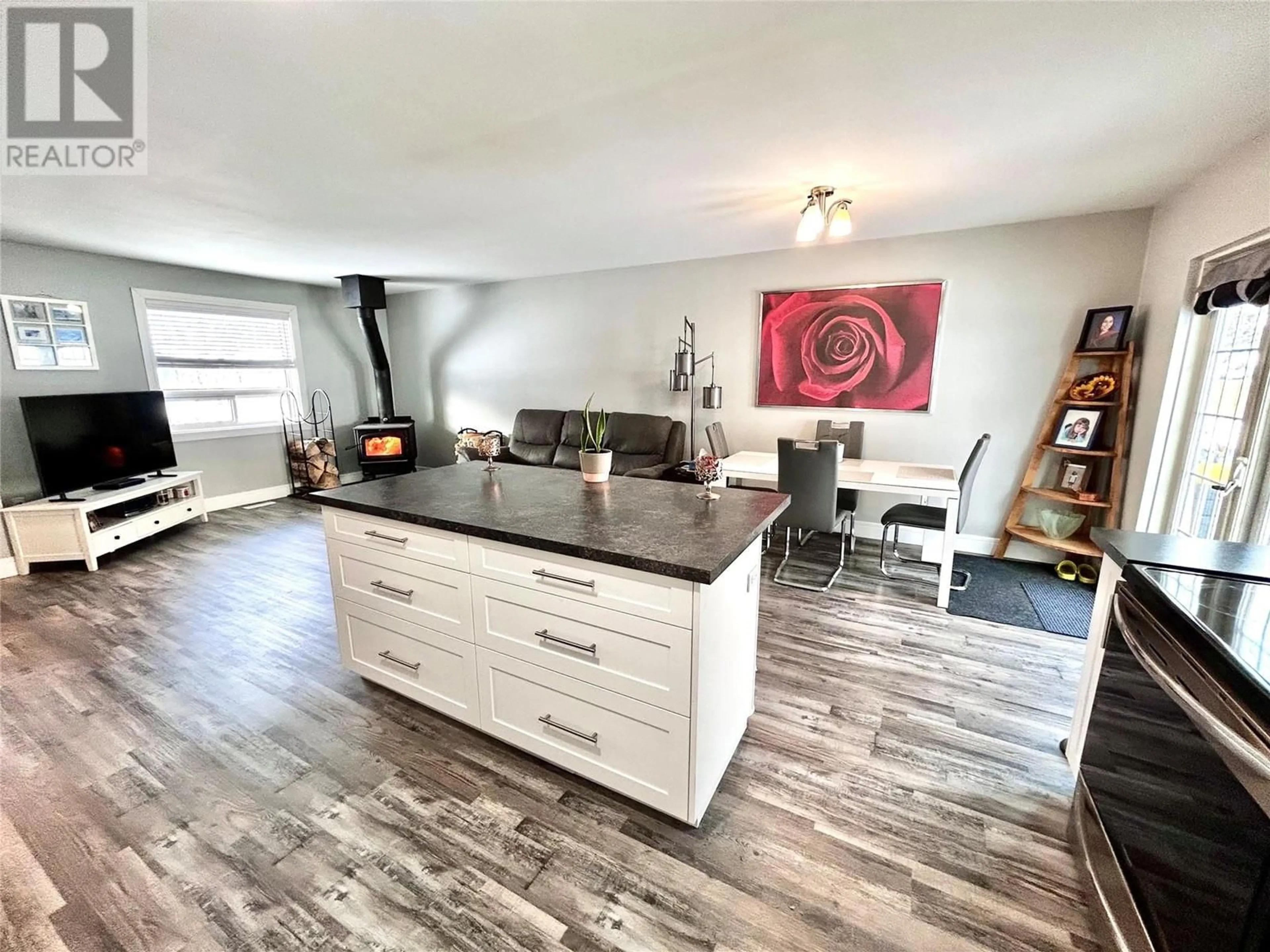 Open concept kitchen, wood/laminate floor for 164 Gwillim Crescent, Tumbler Ridge British Columbia V0C2W0