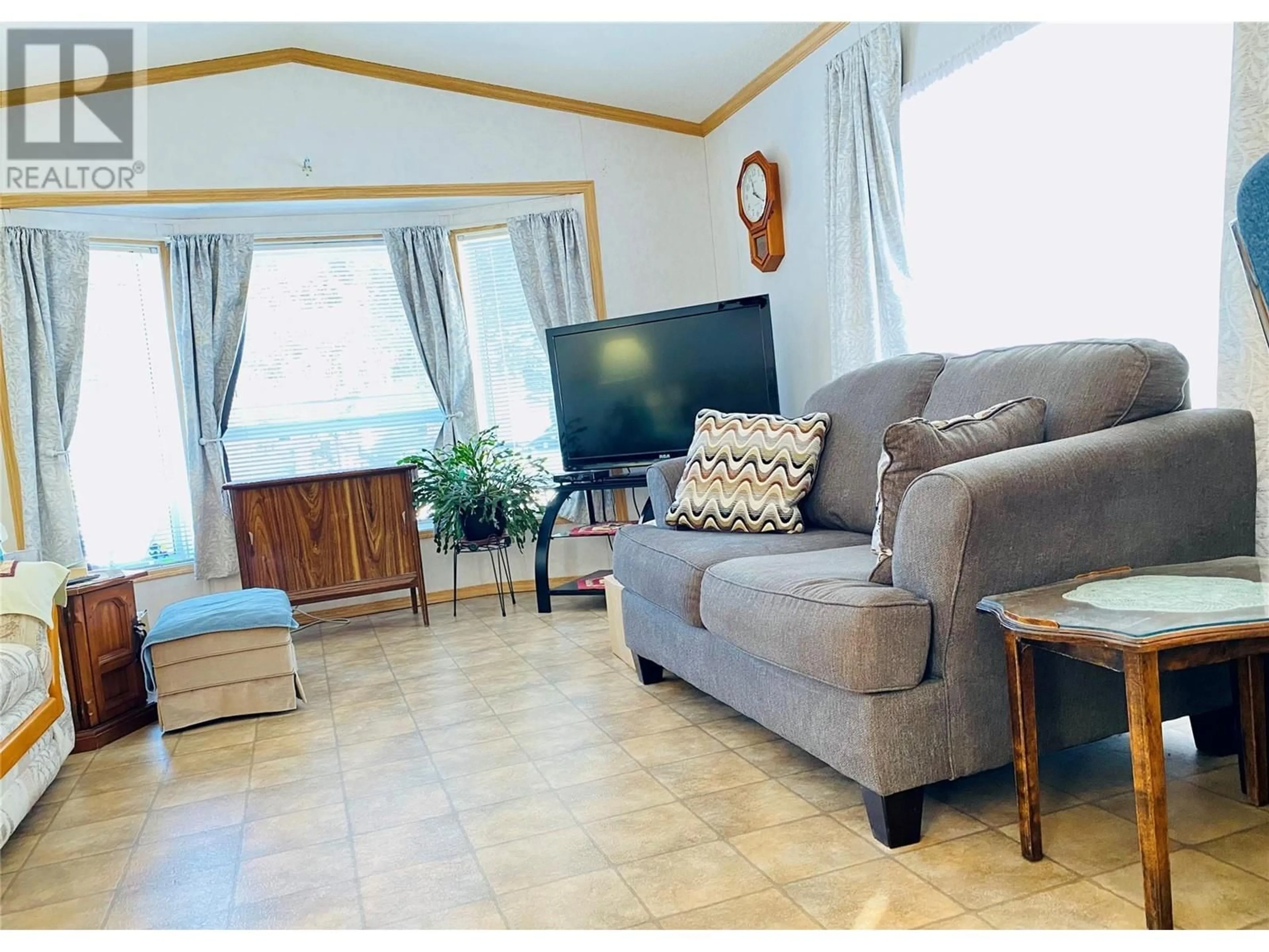 Living room with furniture, wood/laminate floor for B4 - 5455 ALMOND GARDENS ROAD, Grand Forks British Columbia V0H1H4