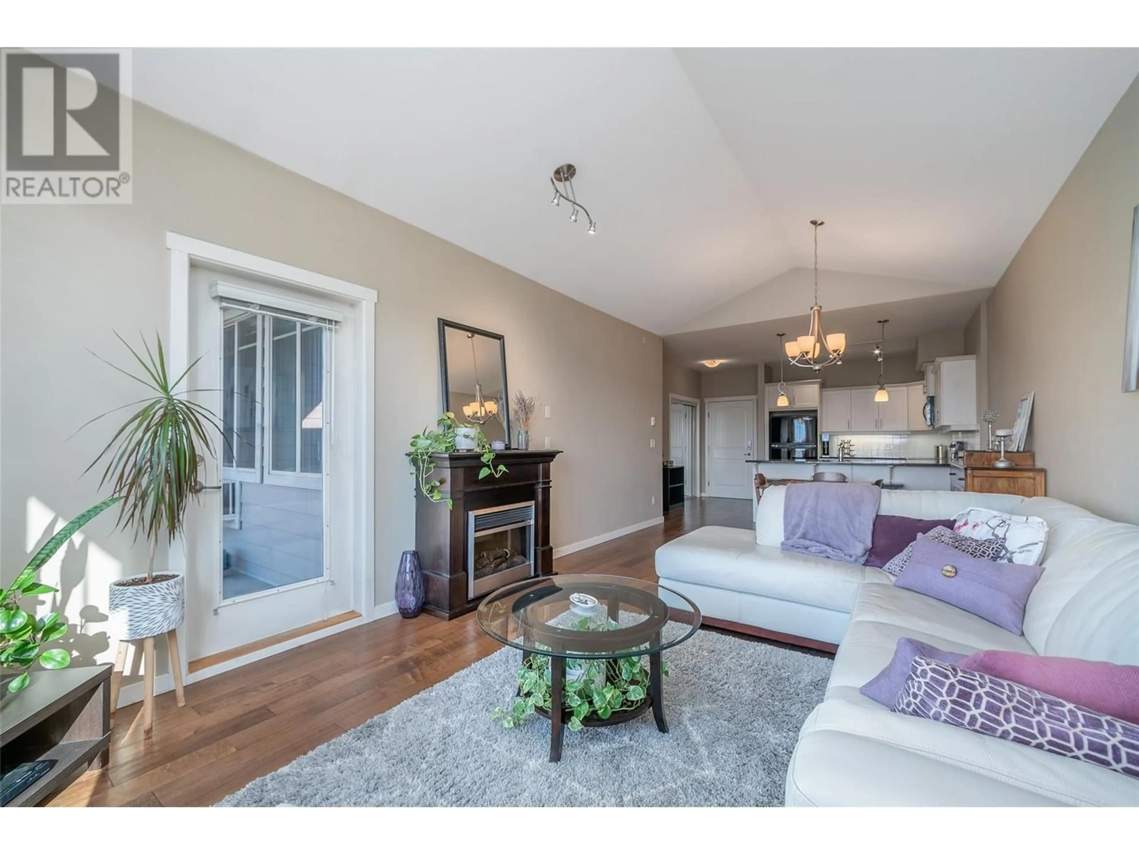 Living room with furniture, wood/laminate floor for 3735 Casorso Road Unit# 413, Kelowna British Columbia V1W5G1