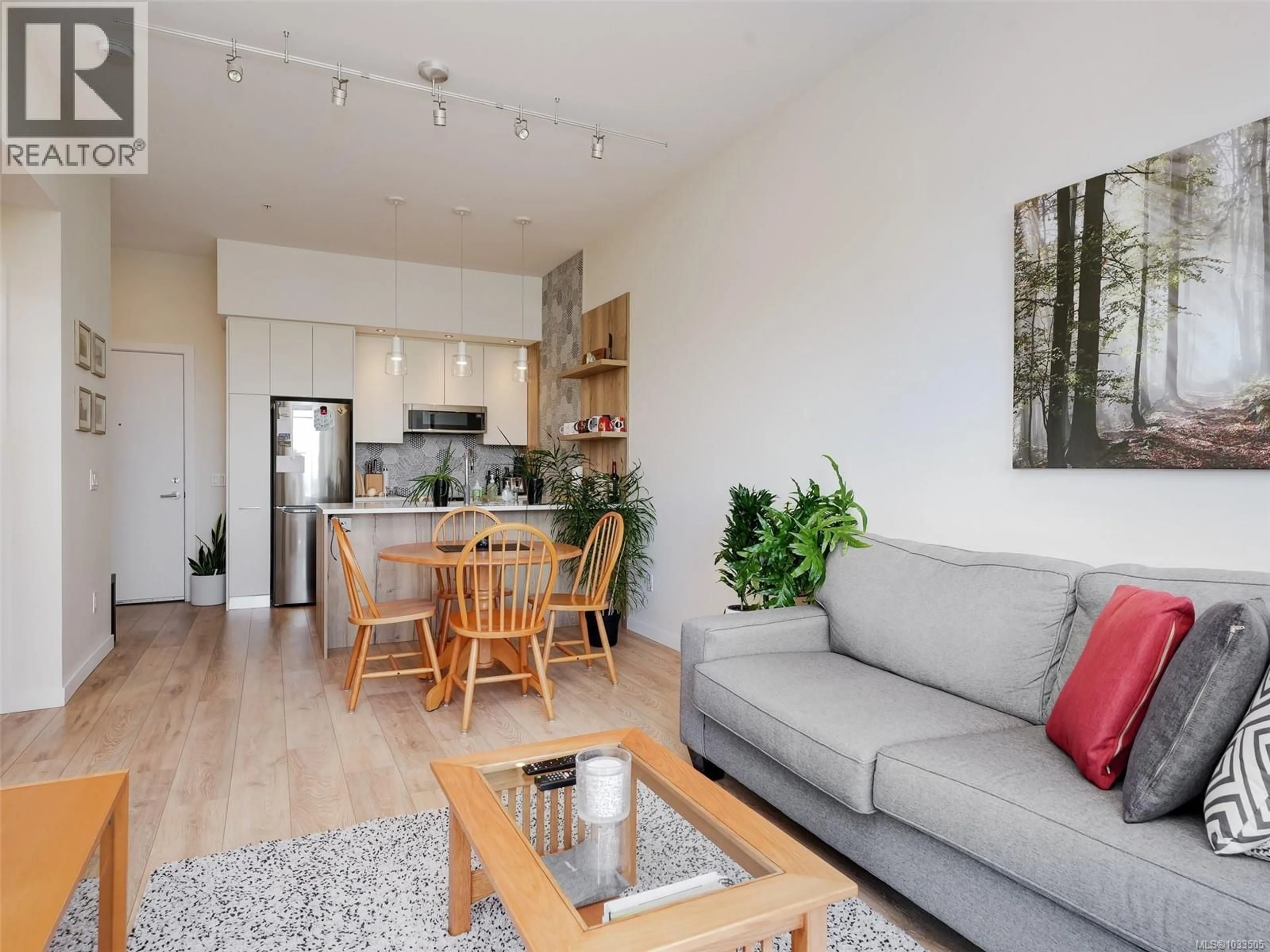 Living room with furniture, wood/laminate floor for 404 - 1588 NORTH DAIRY ROAD, Saanich British Columbia V8T3V4