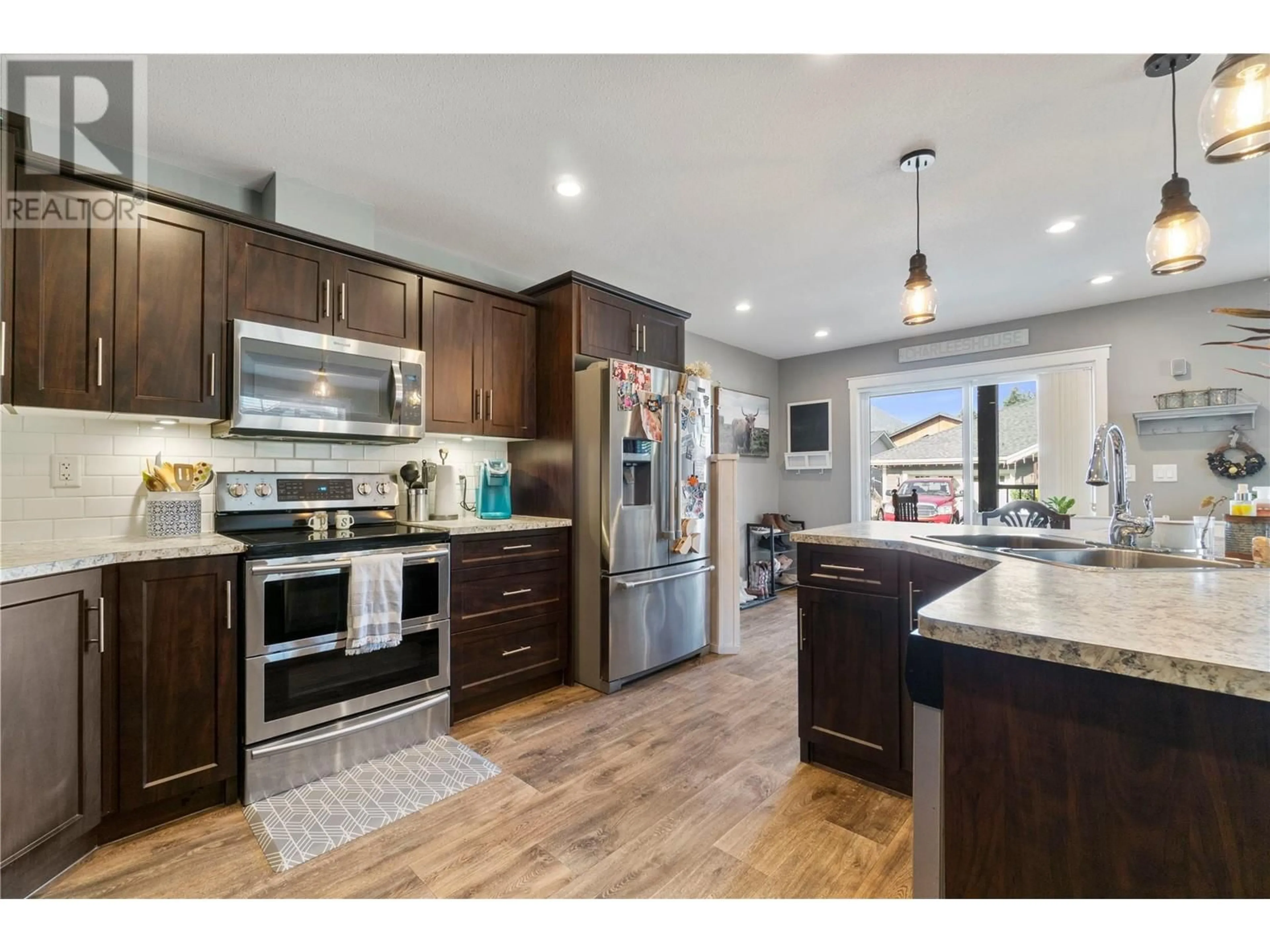 Open concept kitchen, wood/laminate floor for 1137 Willow Row Street, Sicamous British Columbia V0E2V0