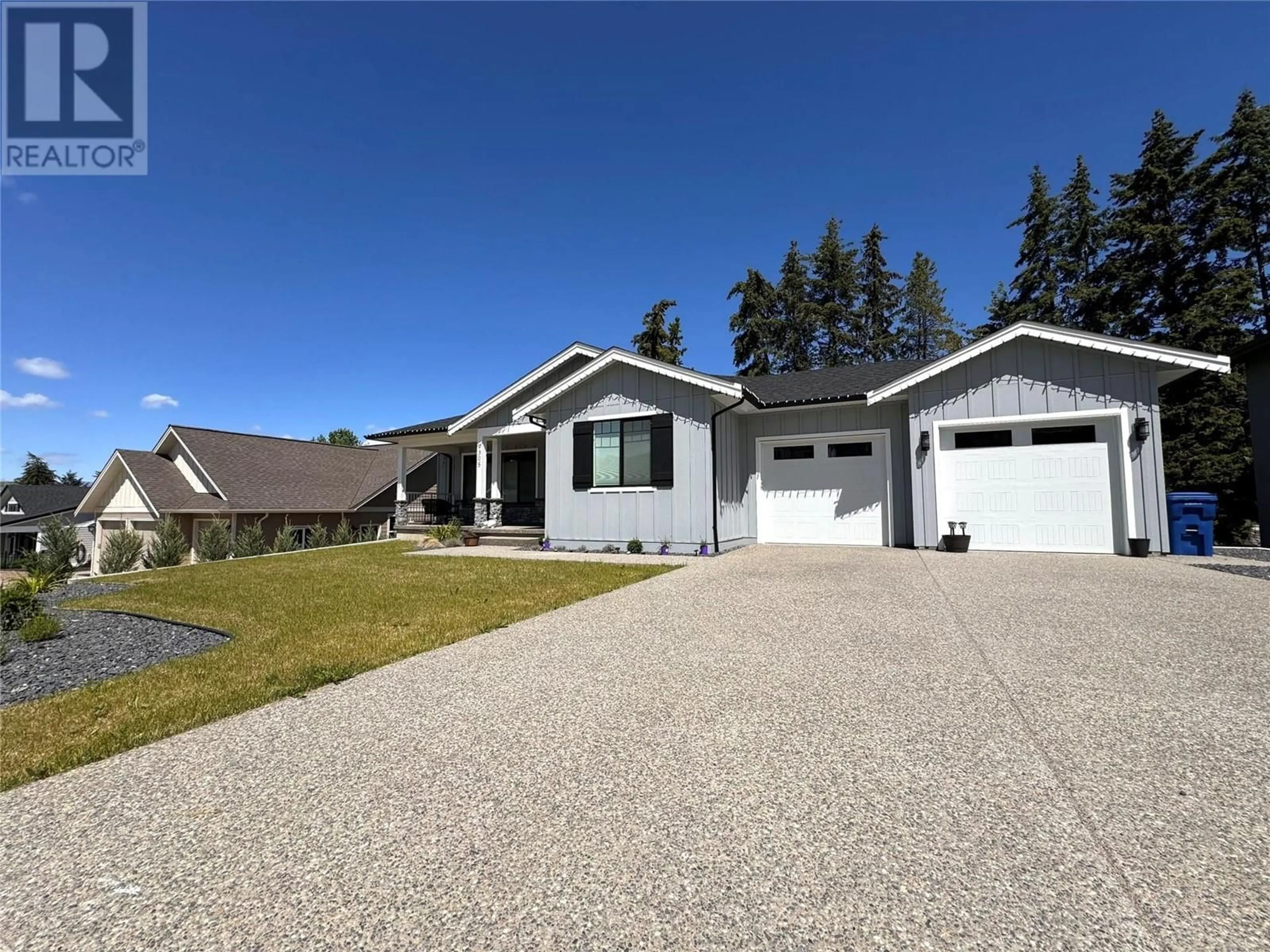 Home with vinyl exterior material, street for 9305 Elm Drive, Coldstream British Columbia V1B0A7