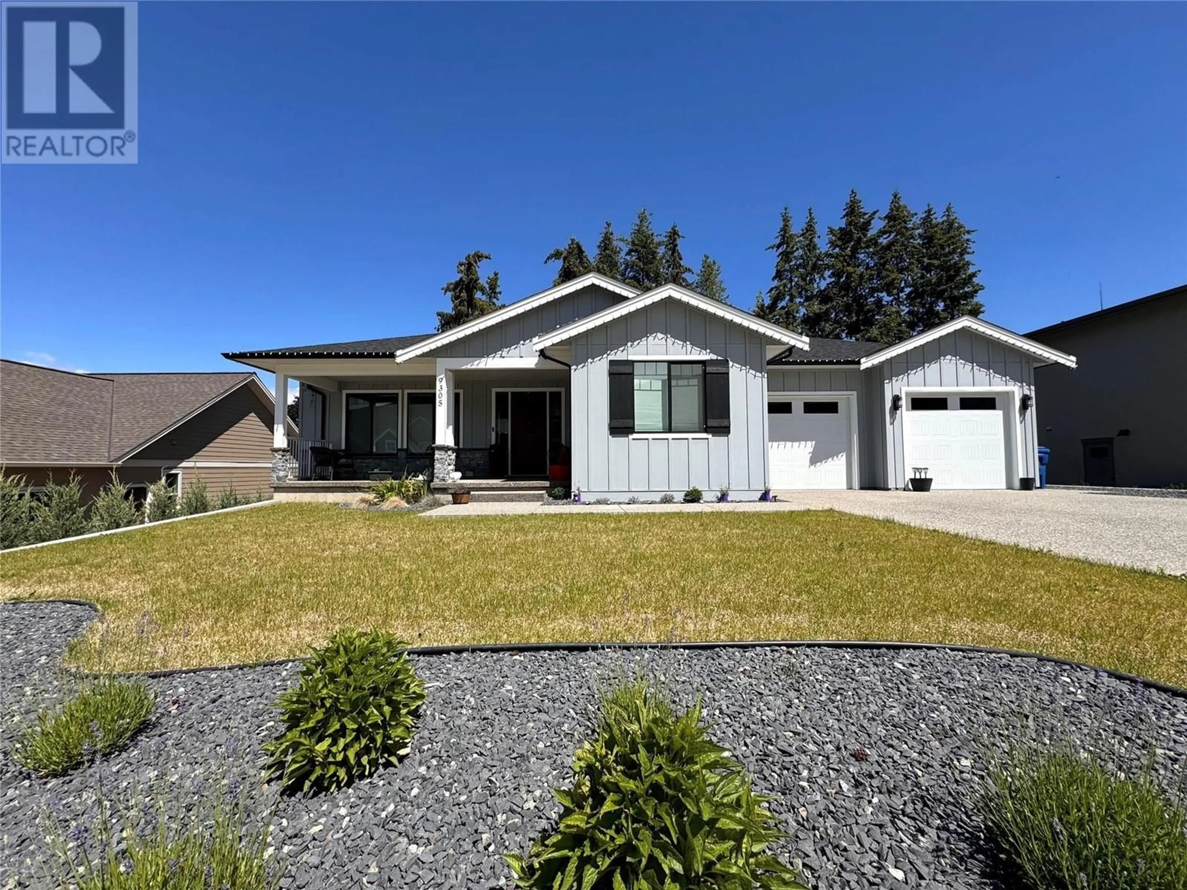 Home with vinyl exterior material, street for 9305 Elm Drive, Coldstream British Columbia V1B0A7