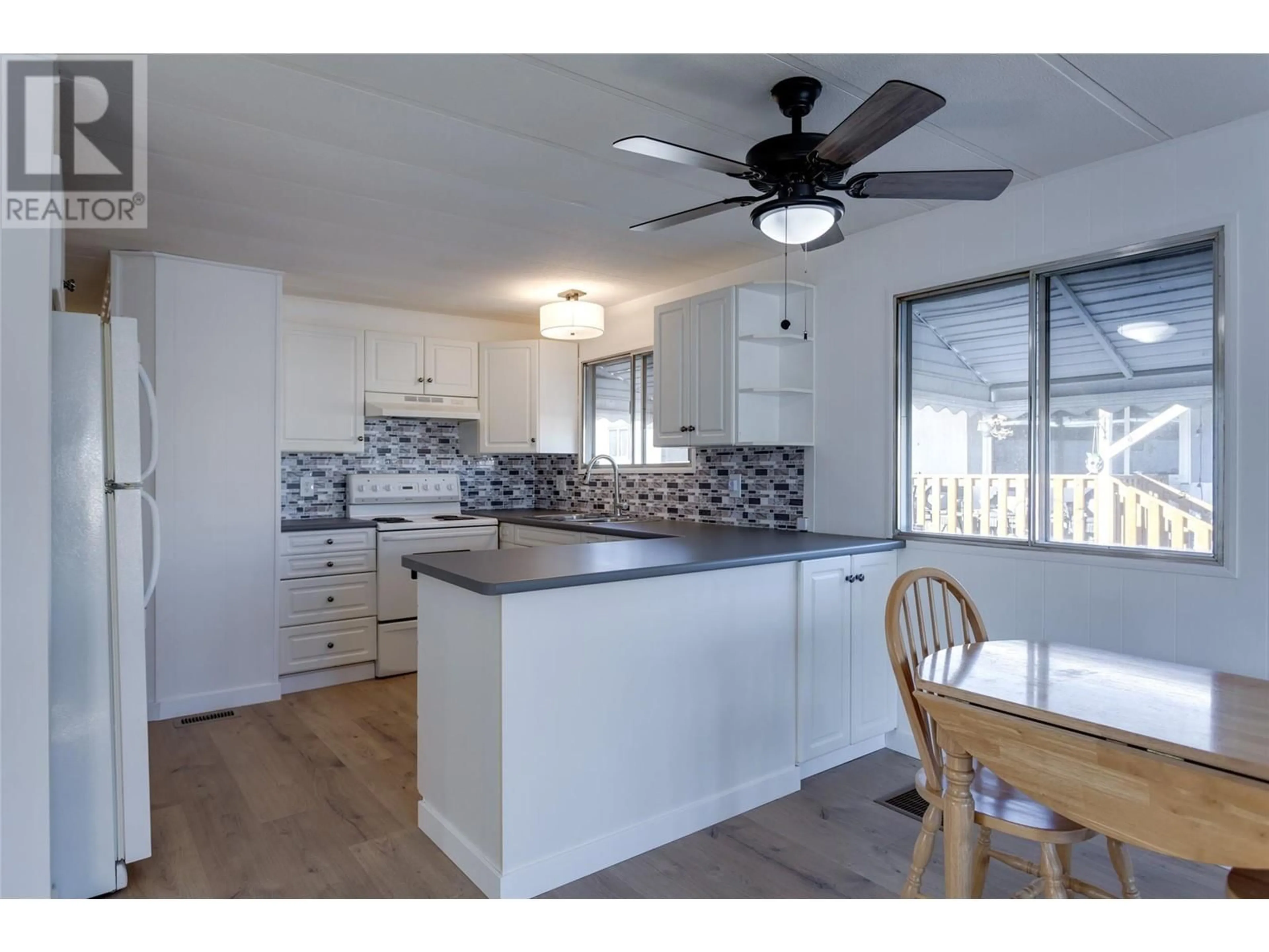 Open concept kitchen, wood/laminate floor for 3745 Lakeshore Road Unit# 131, Kelowna British Columbia V1W3K4