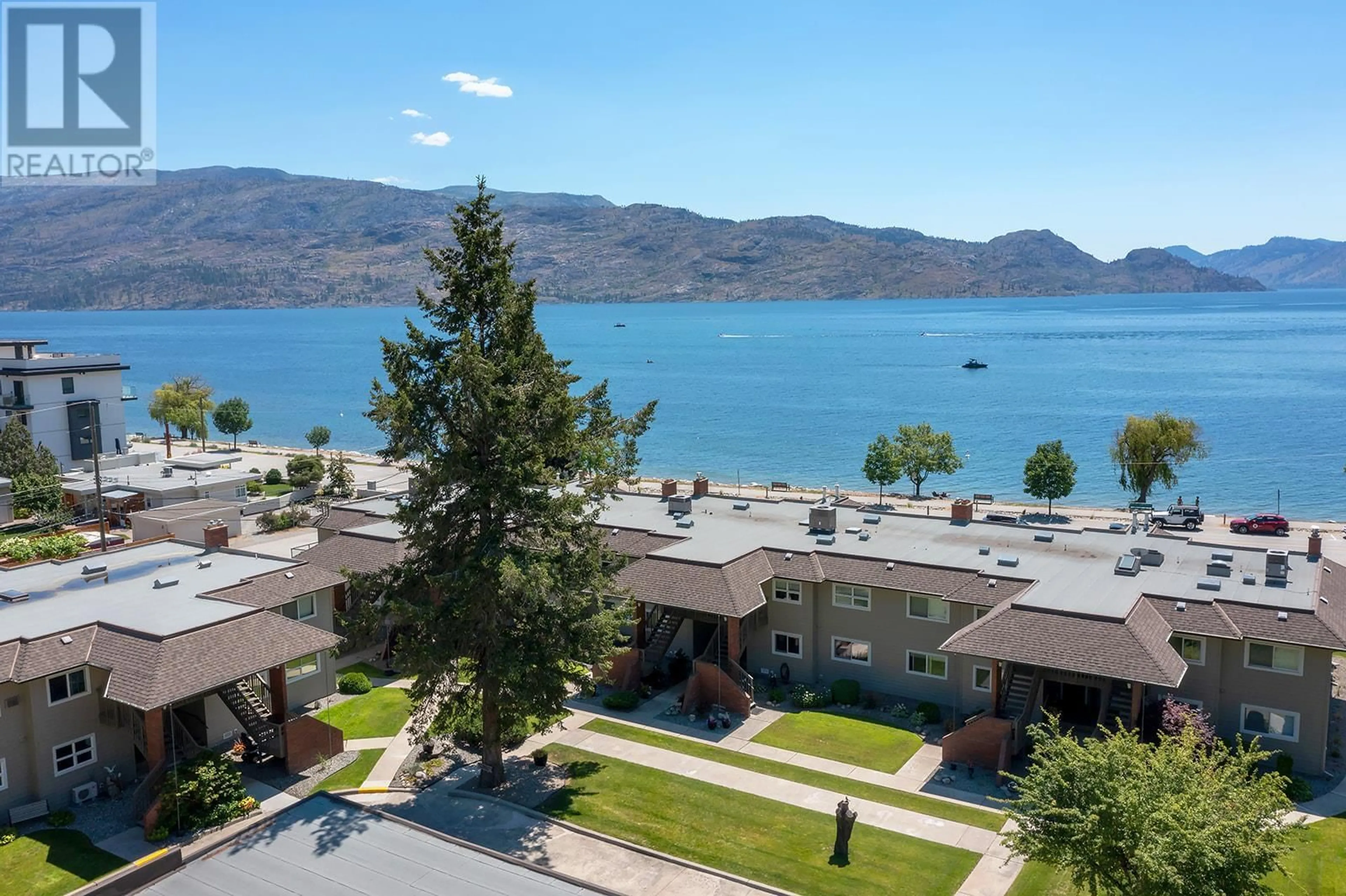 A pic from outside/outdoor area/front of a property/back of a property/a pic from drone, water/lake/river/ocean view for 4340B Beach Avenue Unit# 209, Peachland British Columbia V0H1X0