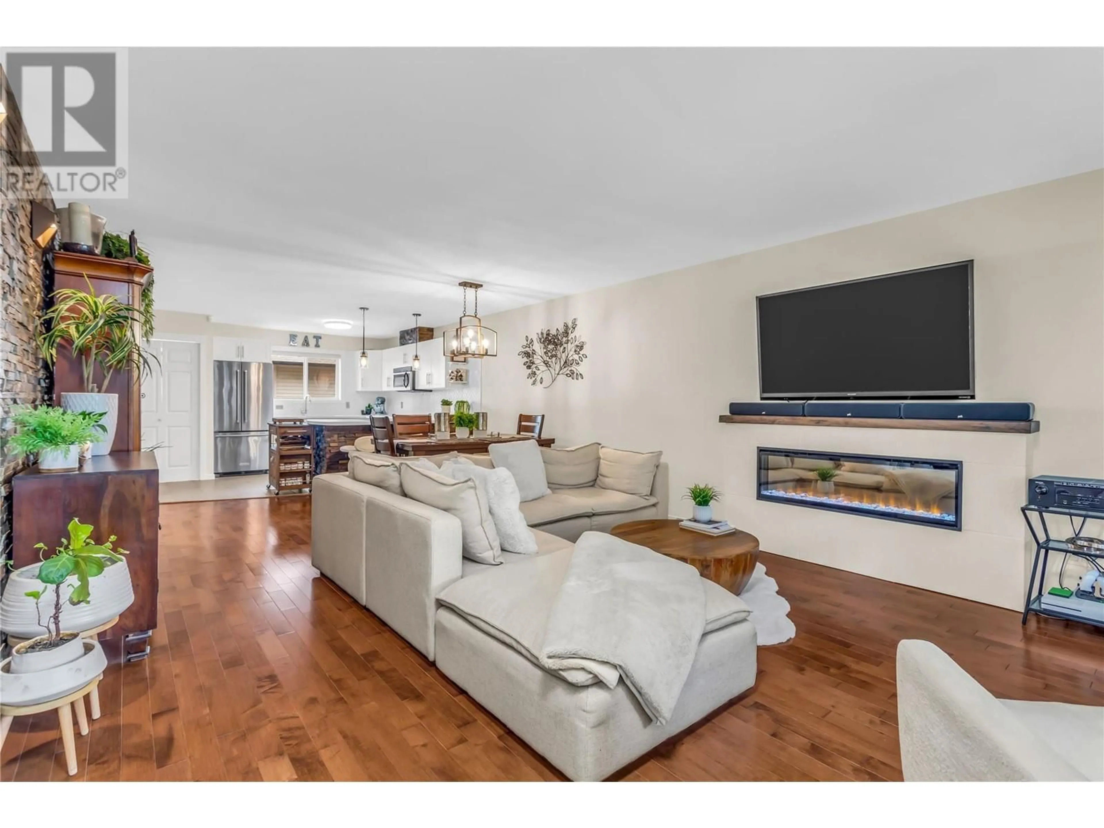 Living room with furniture, wood/laminate floor for 1355 Findlay Road Unit# 122, Kelowna British Columbia V1X8B8