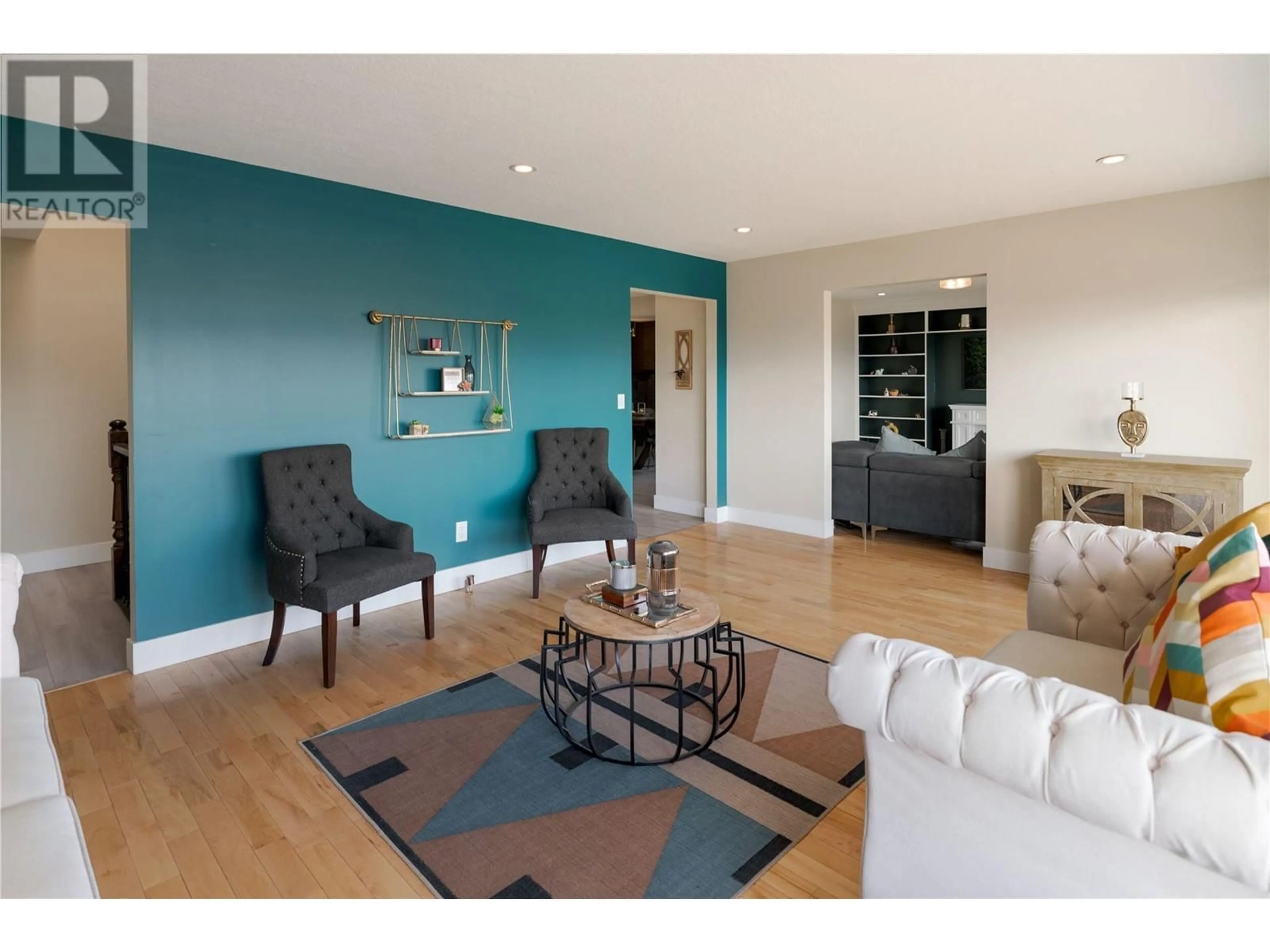 Living room with furniture, wood/laminate floor for 2218 OMINECA PLACE, Kelowna British Columbia V1V1H7