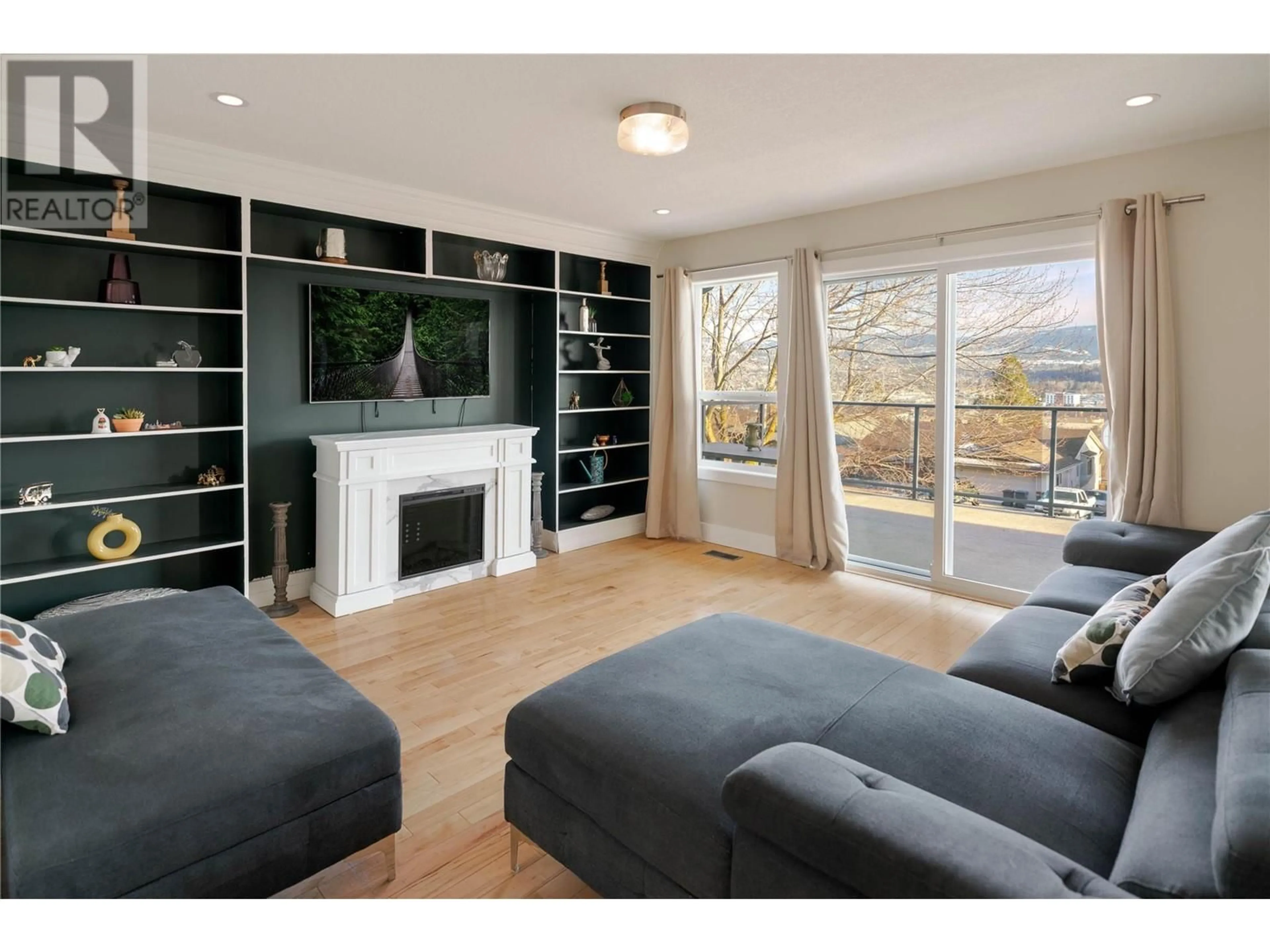 Living room with furniture, wood/laminate floor for 2218 Omineca Place, Kelowna British Columbia V1V1H7