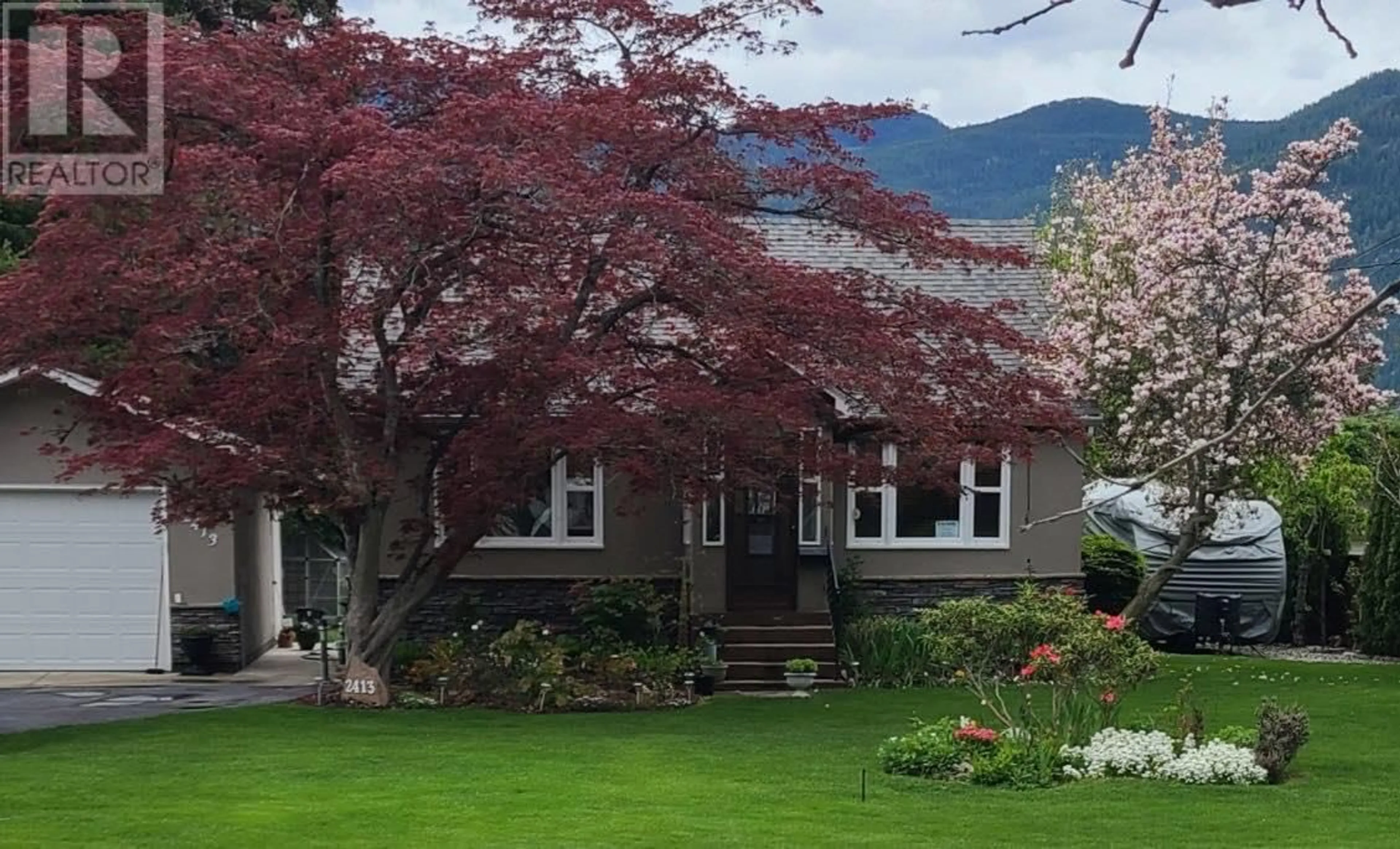 A pic from outside/outdoor area/front of a property/back of a property/a pic from drone, mountain view for 2413 10th Avenue, Castlegar British Columbia V1N3A1