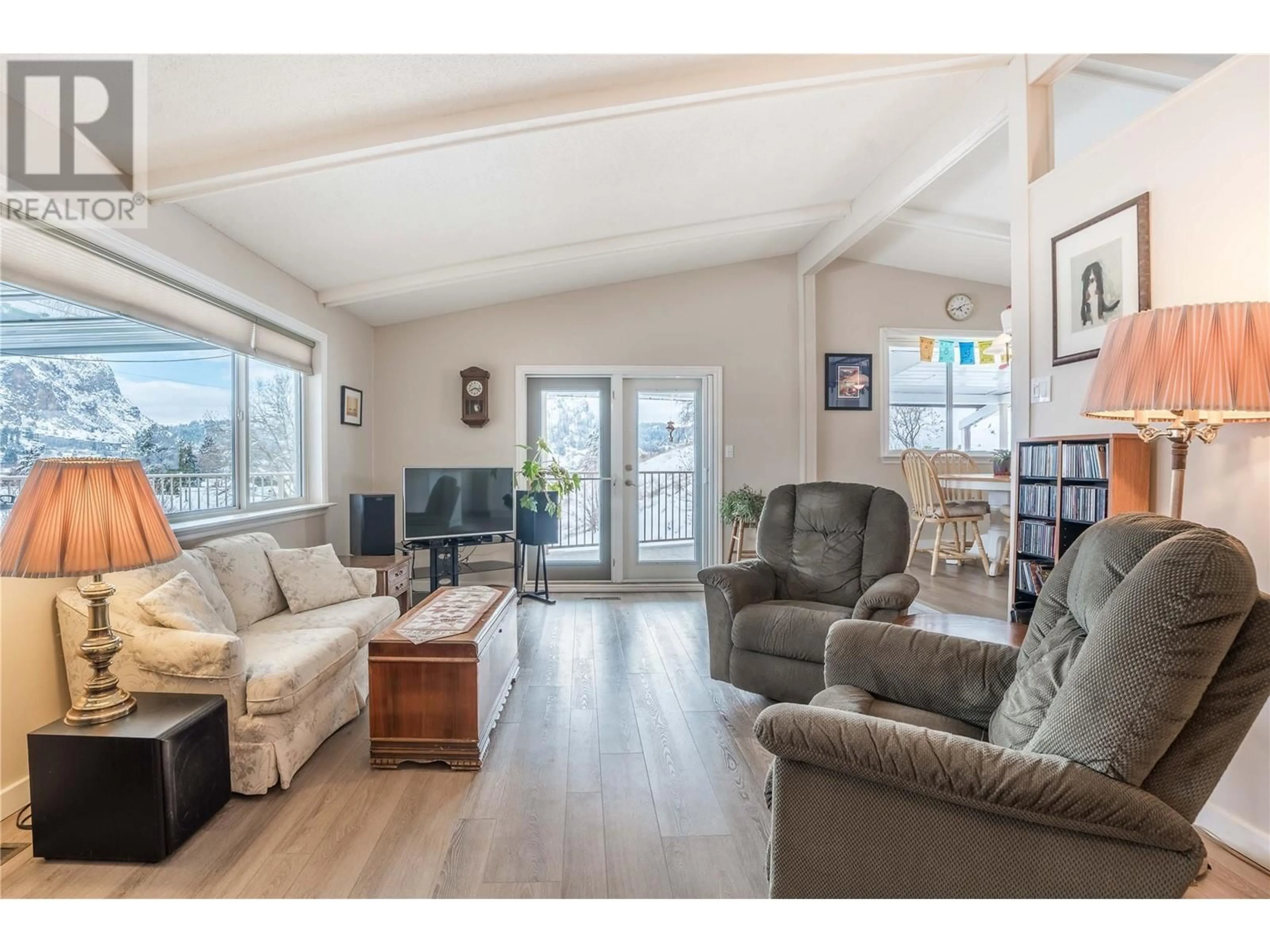 Living room with furniture, wood/laminate floor for 12406 Wright Avenue, Summerland British Columbia V0H1Z0