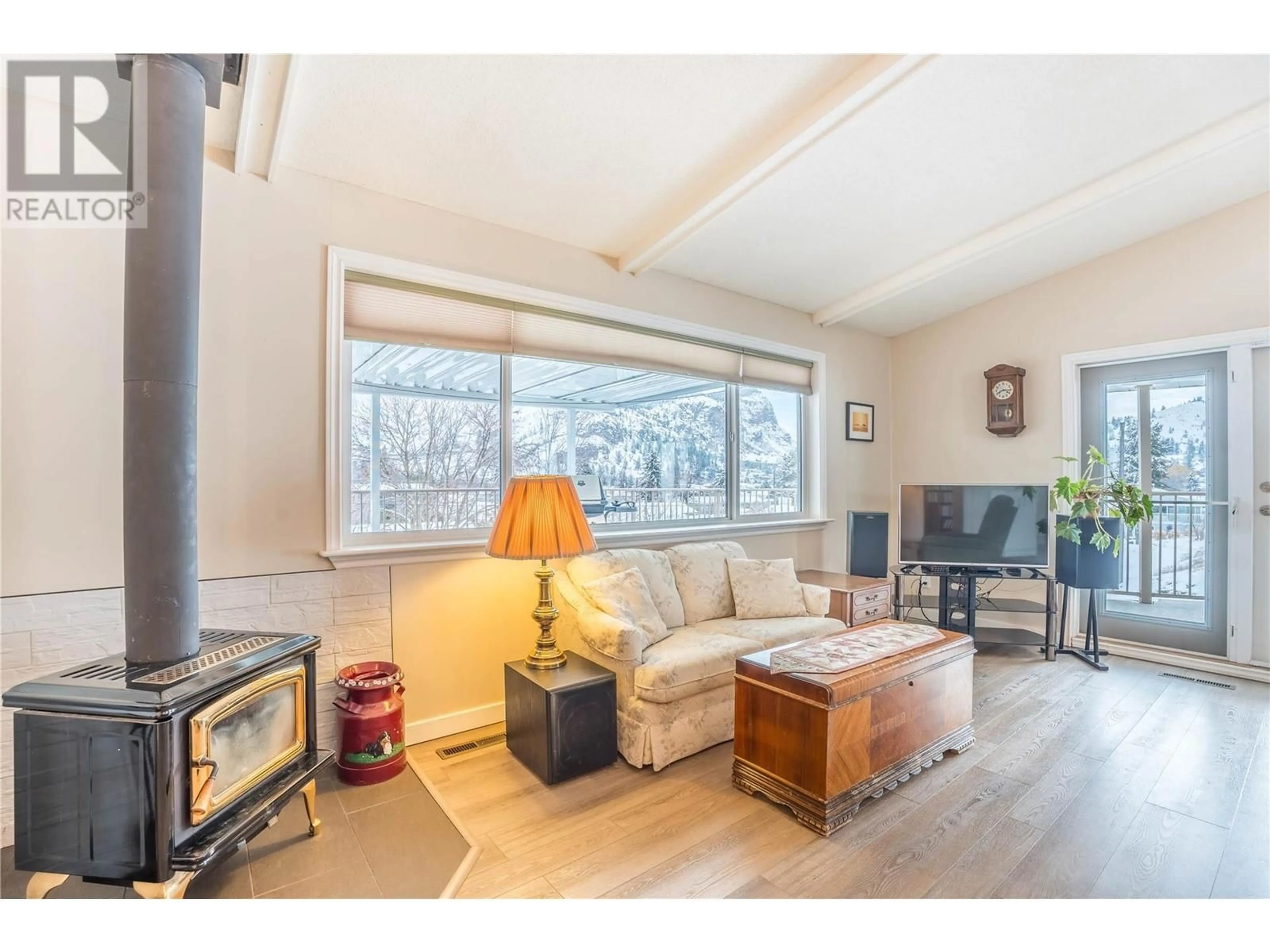 Living room with furniture, wood/laminate floor for 12406 Wright Avenue, Summerland British Columbia V0H1Z0