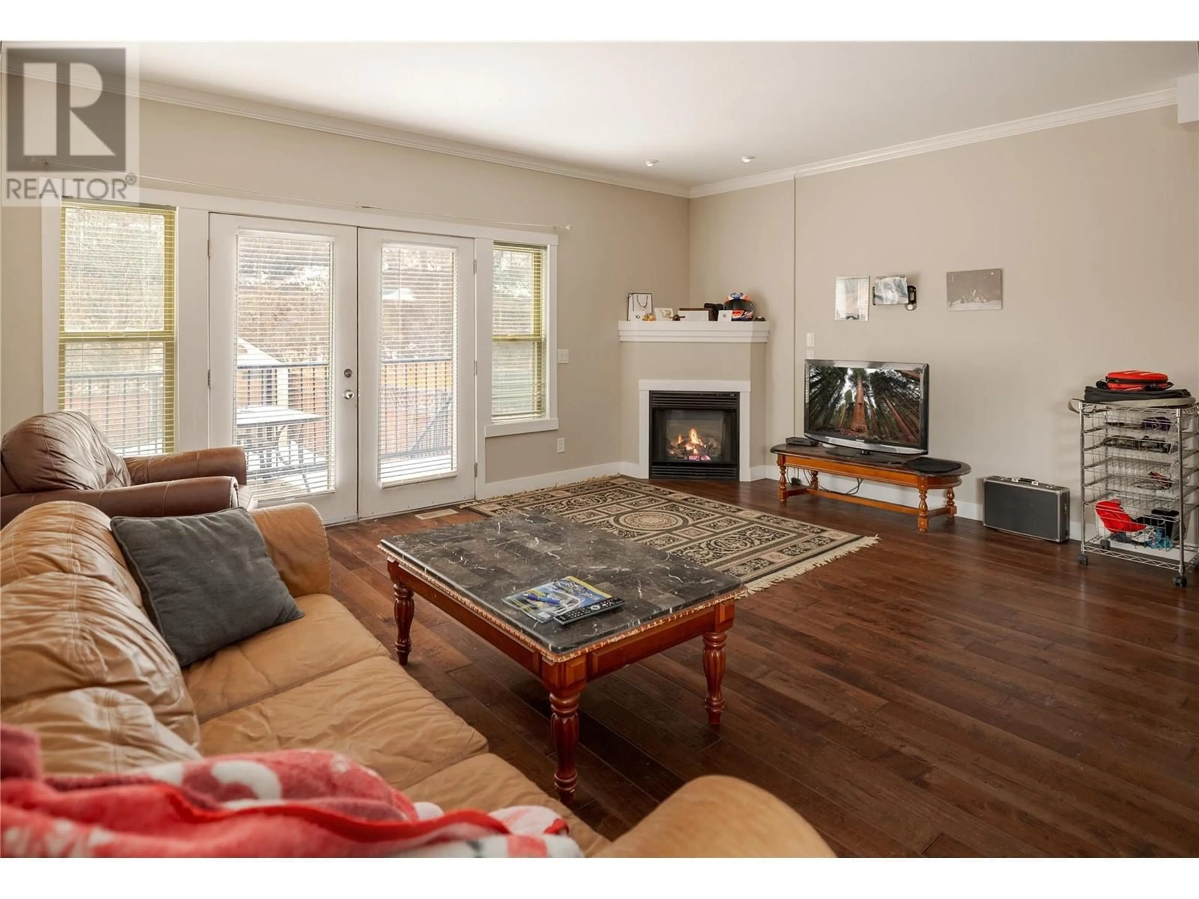 Living room with furniture, wood/laminate floor for 10392 Bottom Wood Lake Road Unit# A, Lake Country British Columbia V4V1T9