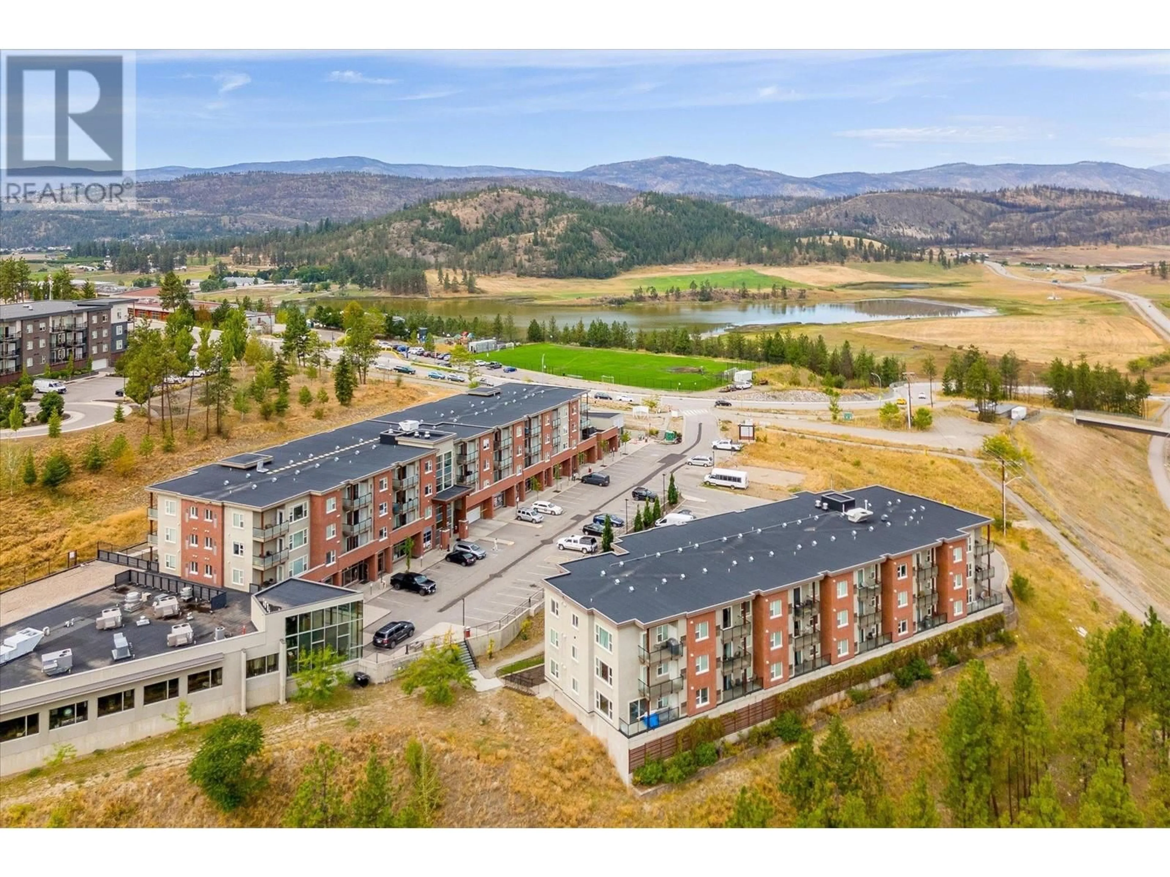 A pic from outside/outdoor area/front of a property/back of a property/a pic from drone, mountain view for 975 Academy Way Unit# 301, Kelowna British Columbia V1V3C8