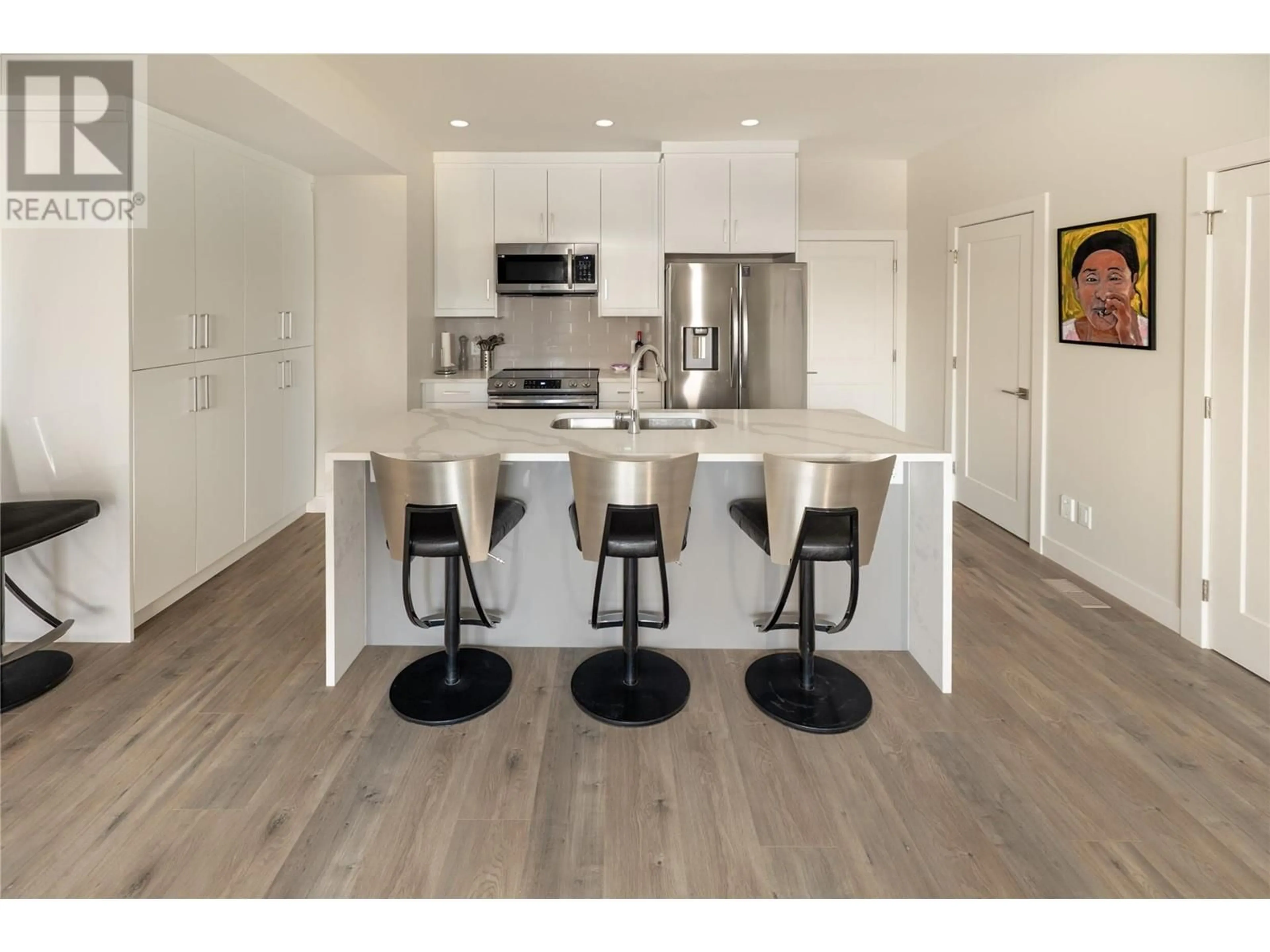 Open concept kitchen, wood/laminate floor for 115 Wyndham Crescent Unit# 23, Kelowna British Columbia V1V1Z1