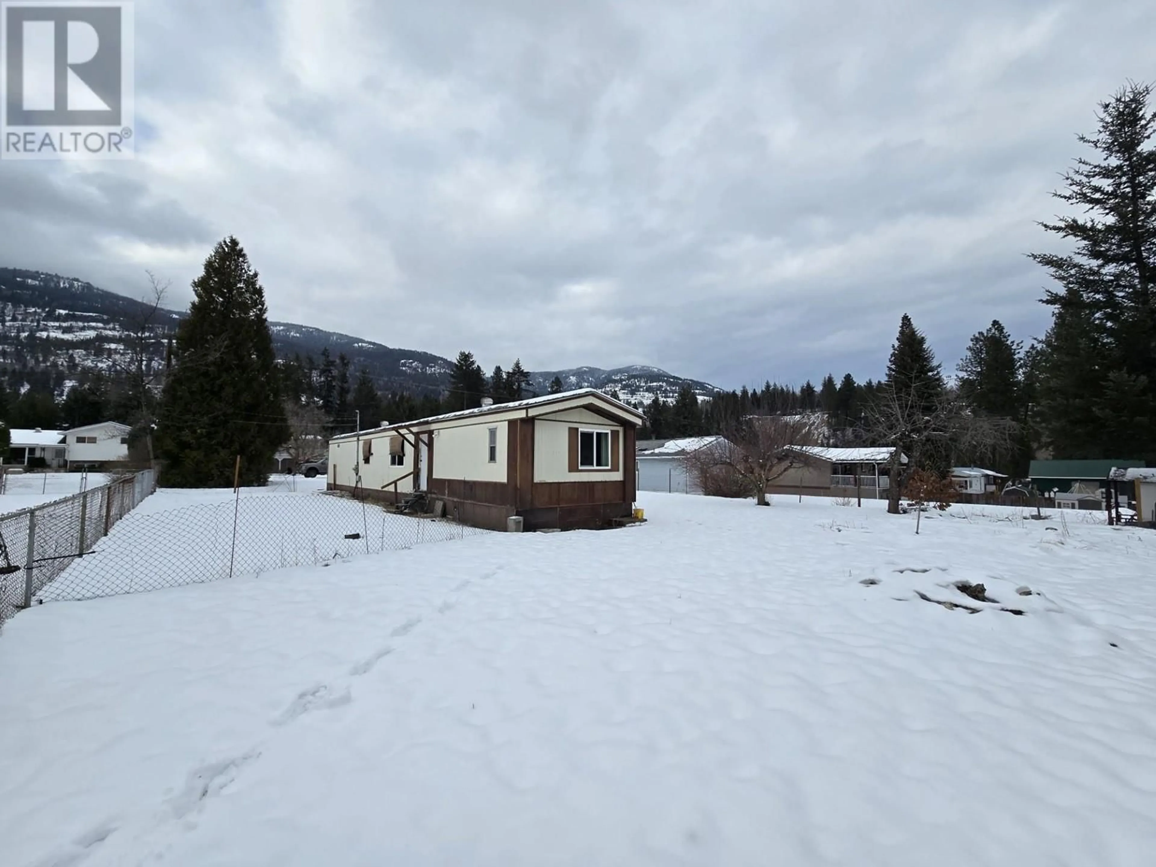 A pic from outside/outdoor area/front of a property/back of a property/a pic from drone, mountain view for 810 SMITH Crescent, Genelle British Columbia V0G1G0