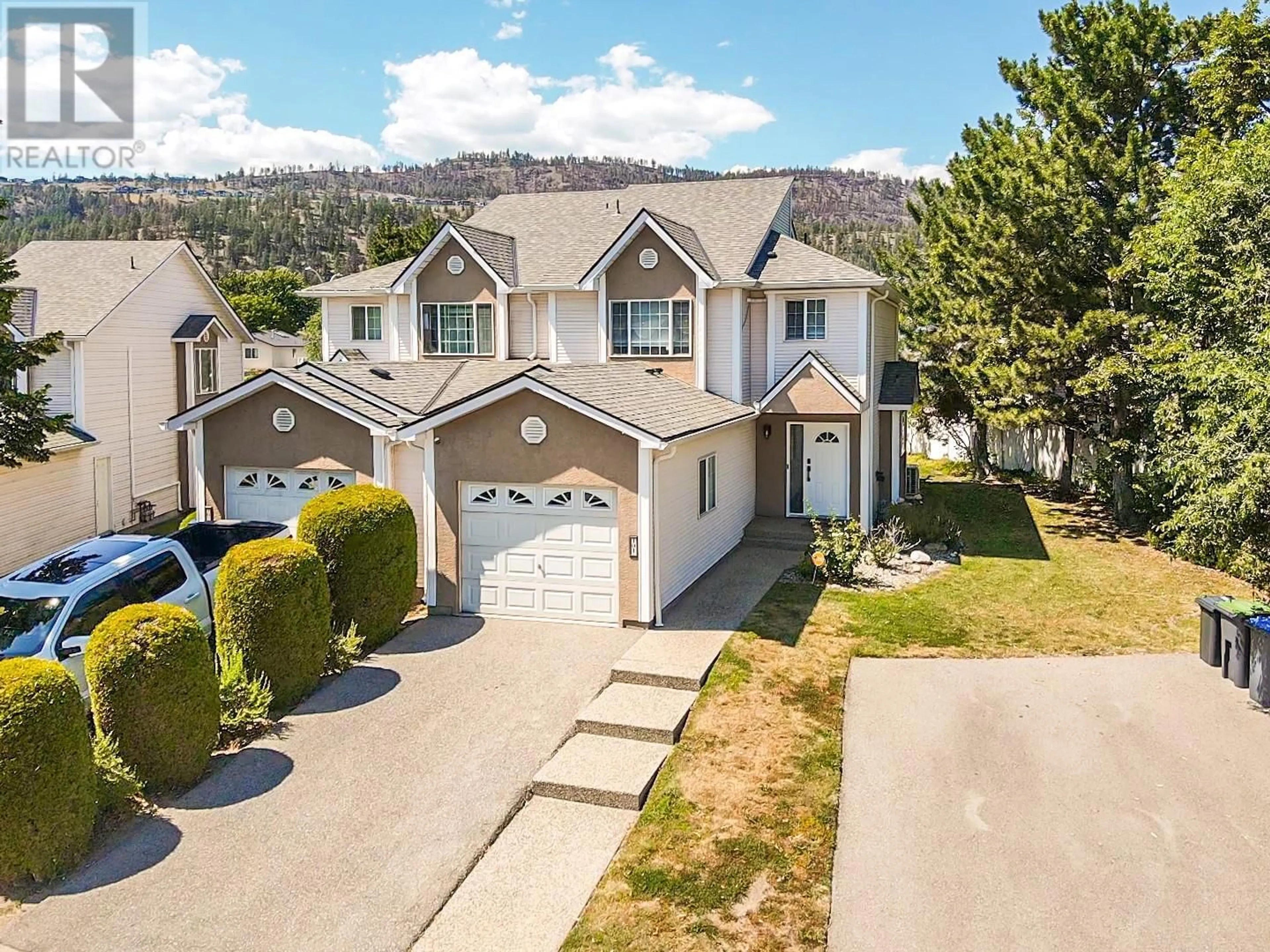 A pic from outside/outdoor area/front of a property/back of a property/a pic from drone, mountain view for 160 Celano Crescent Unit# 101, Kelowna British Columbia V1V1X9