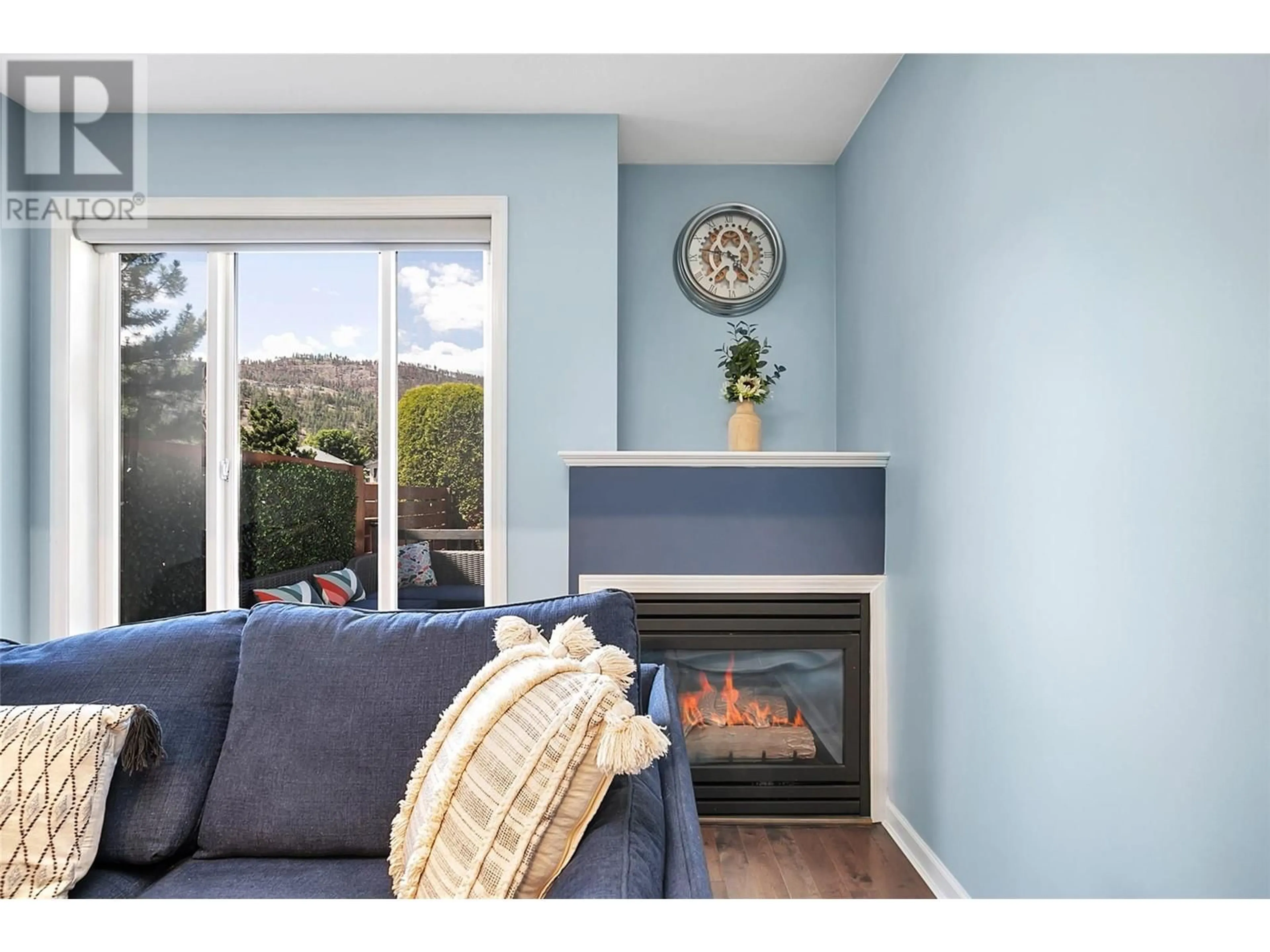 Living room with furniture, wood/laminate floor for 160 Celano Crescent Unit# 101, Kelowna British Columbia V1V1X9