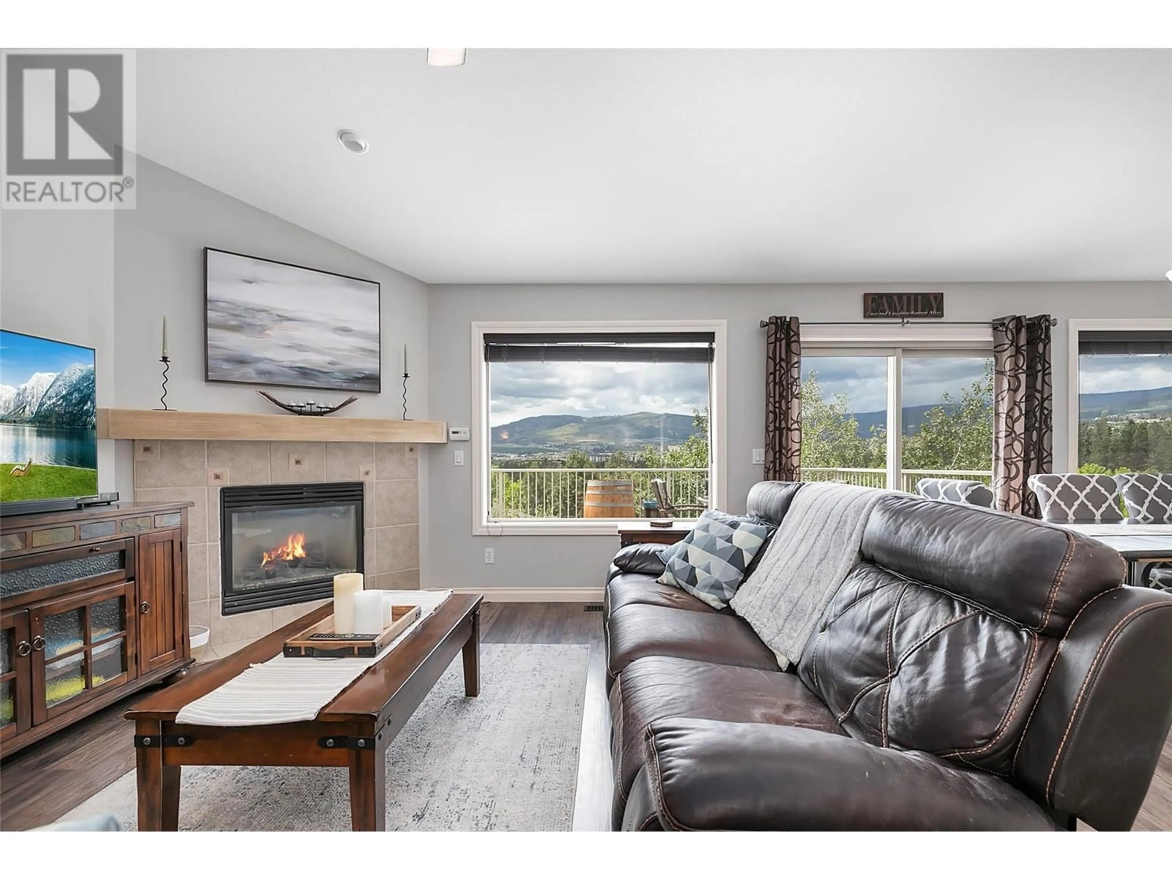 Living room with furniture, wood/laminate floor for 3397 Merlot Way, West Kelowna British Columbia V4T2X4