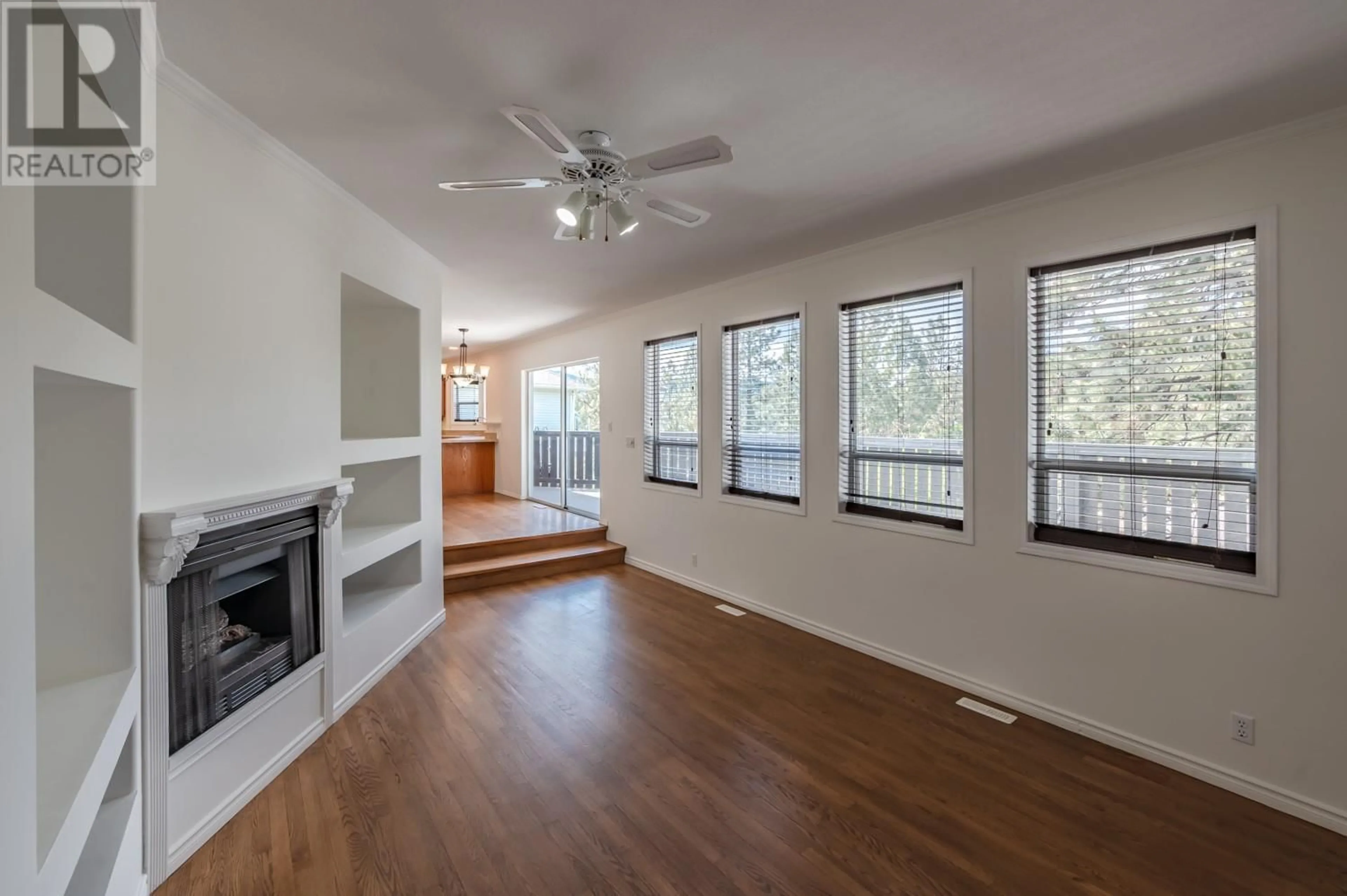 Living room with furniture, wood/laminate floor for 12594 Sunset Place, Summerland British Columbia V0H1Z8