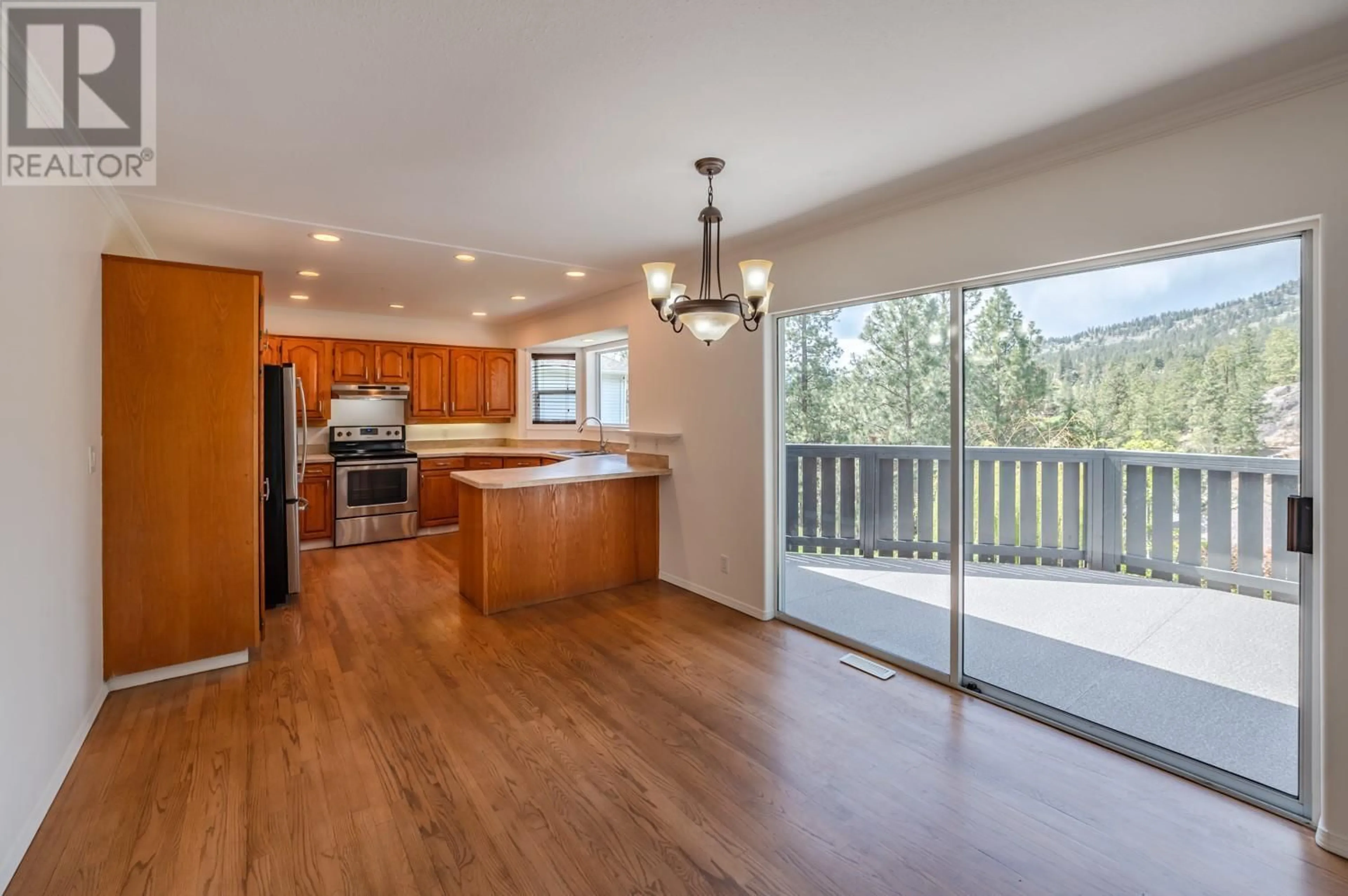 Open concept kitchen, wood/laminate floor for 12594 Sunset Place, Summerland British Columbia V0H1Z8