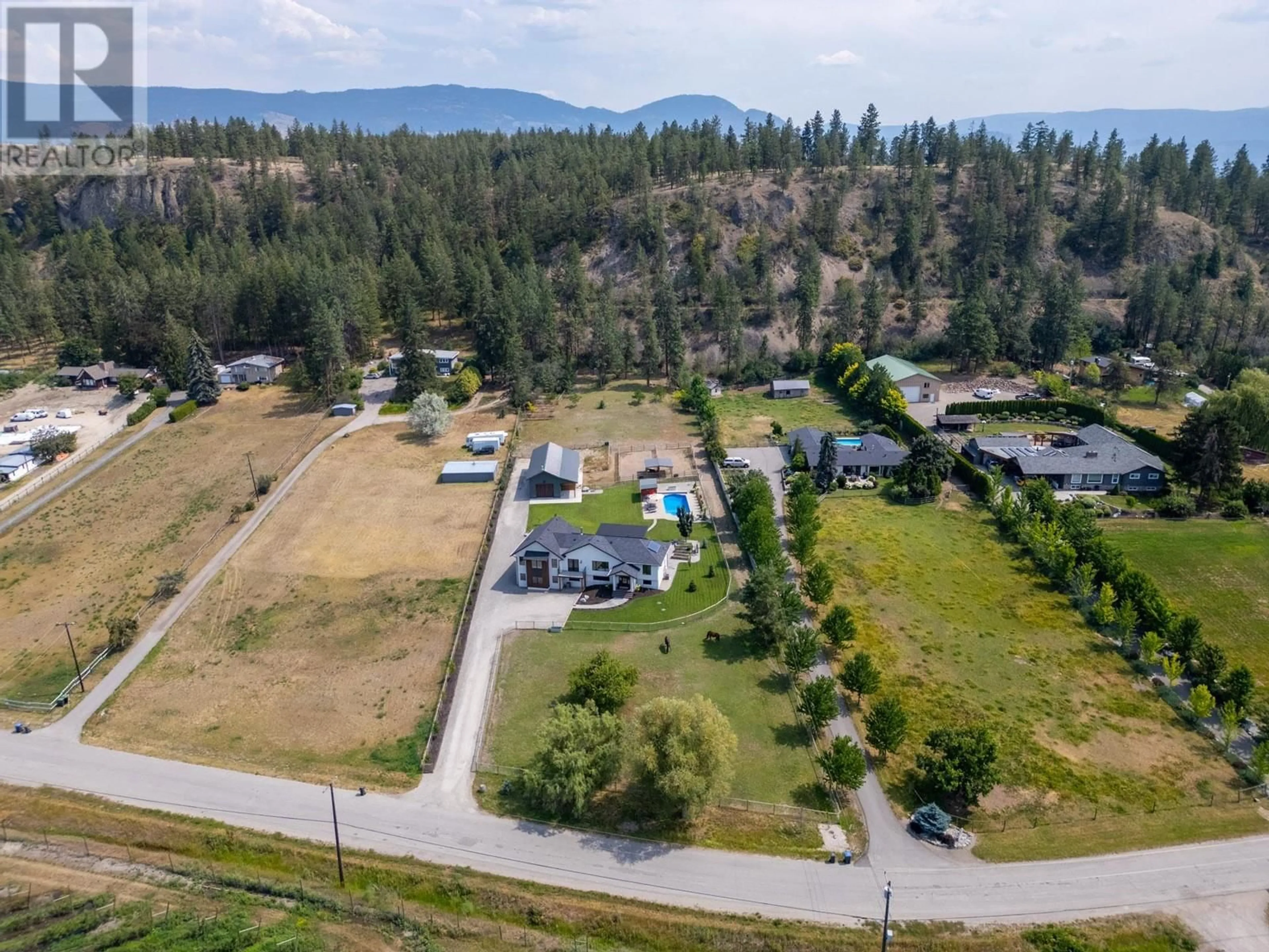 A pic from outside/outdoor area/front of a property/back of a property/a pic from drone, mountain view for 667 Curtis Road, Kelowna British Columbia V1V2C9