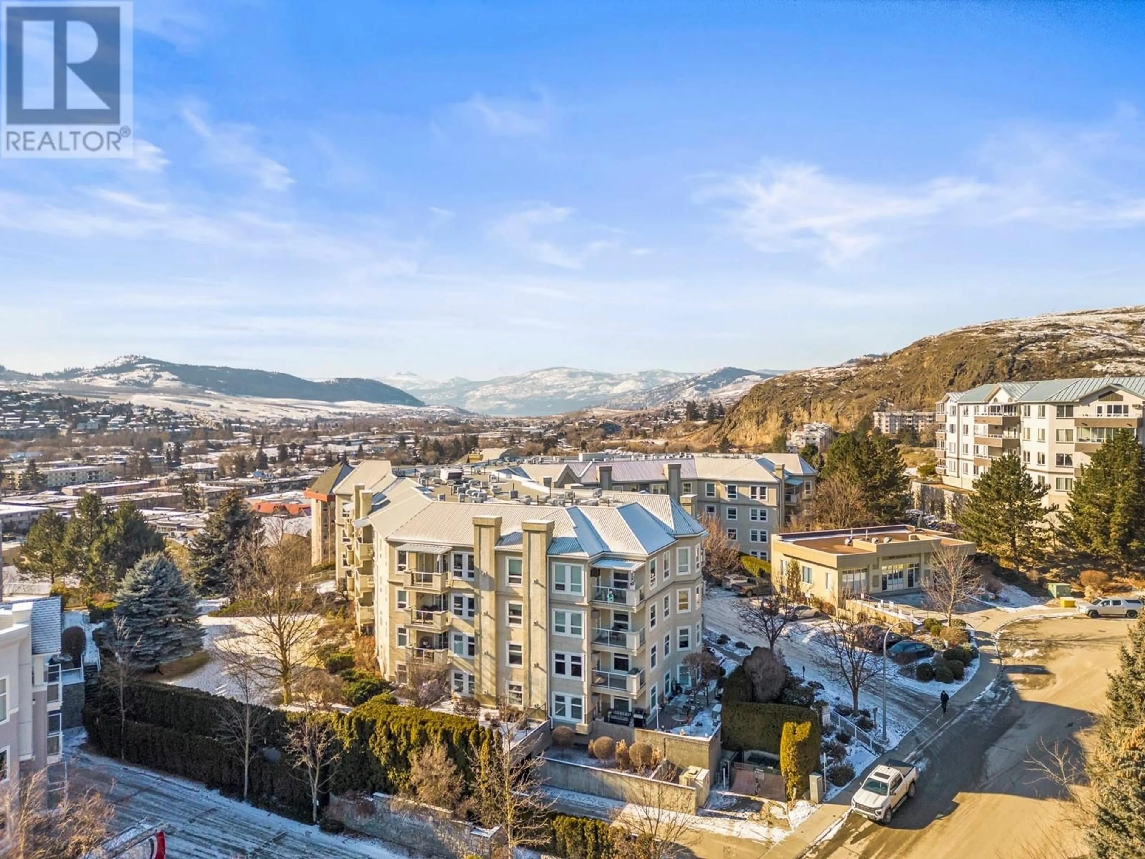 A pic from outside/outdoor area/front of a property/back of a property/a pic from drone, city buildings view from balcony for 3300 Centennial Drive Unit# 104, Vernon British Columbia V1T9M5